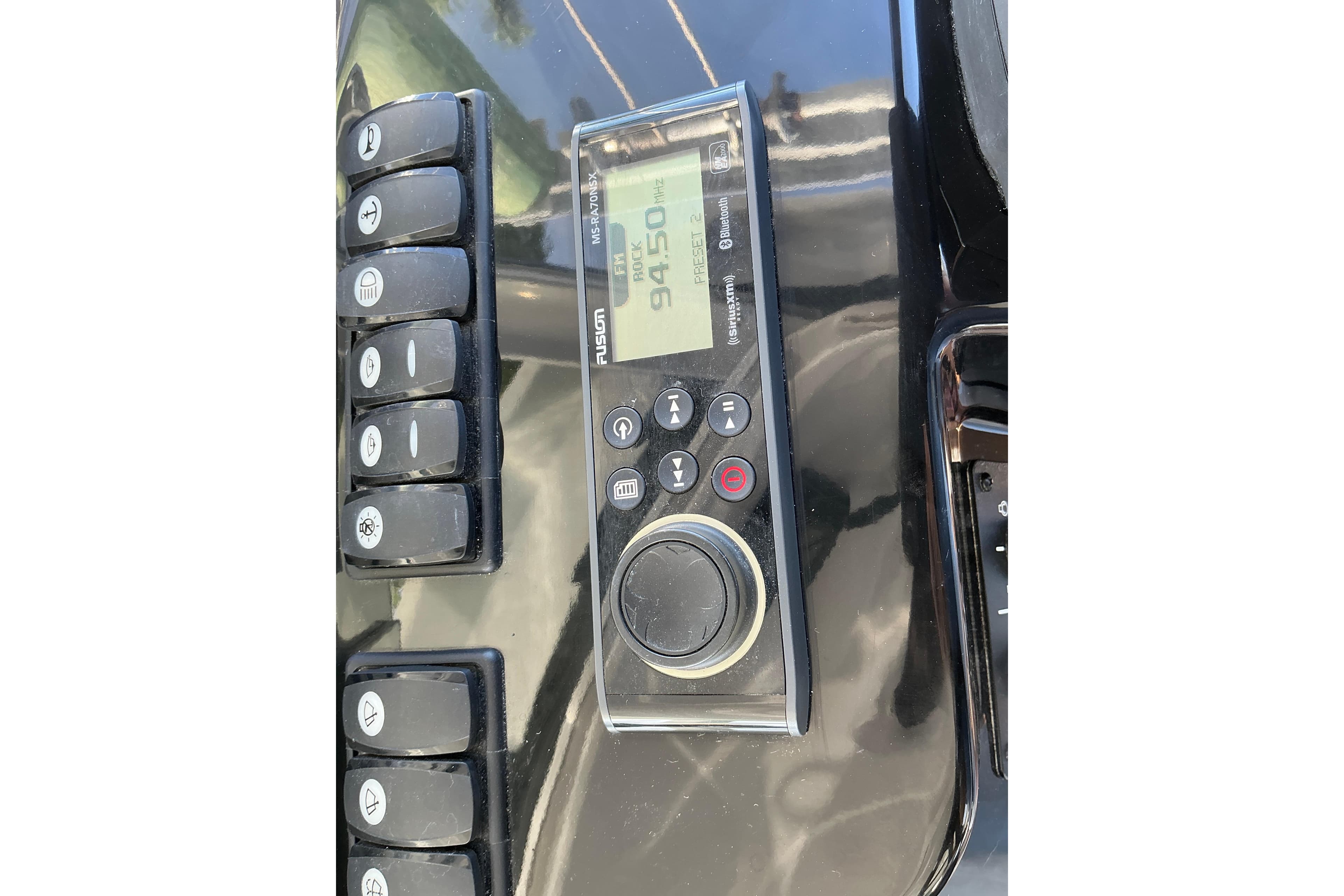 Control panel of a 2022 Beneteau Antares 9 boat with radio and buttons.