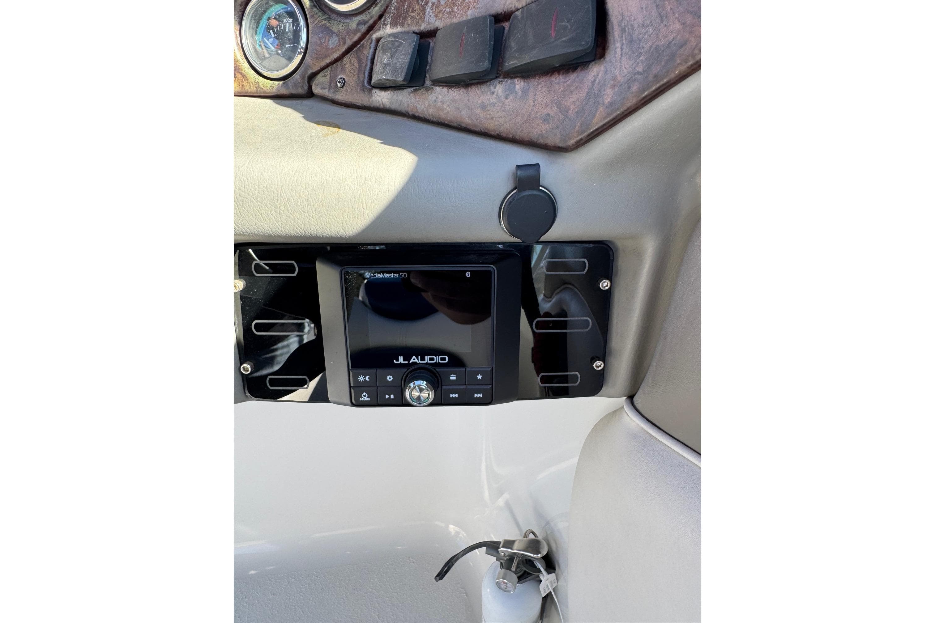 2005 Crownline 236 LS boat dashboard with JL Audio system and controls.