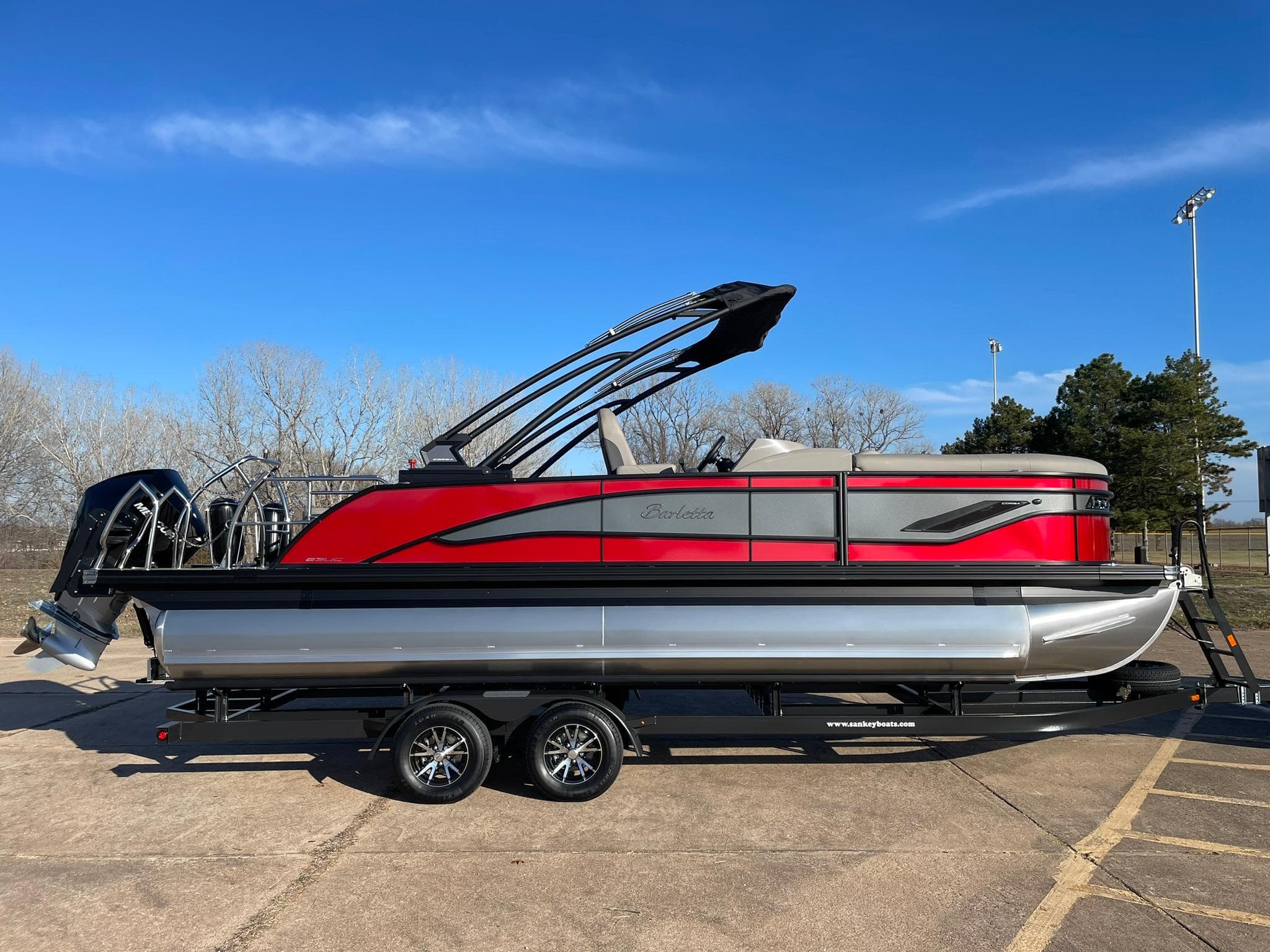 2024 Barletta CORSA 23UCA pontoon boat with red and silver exterior on a trailer.