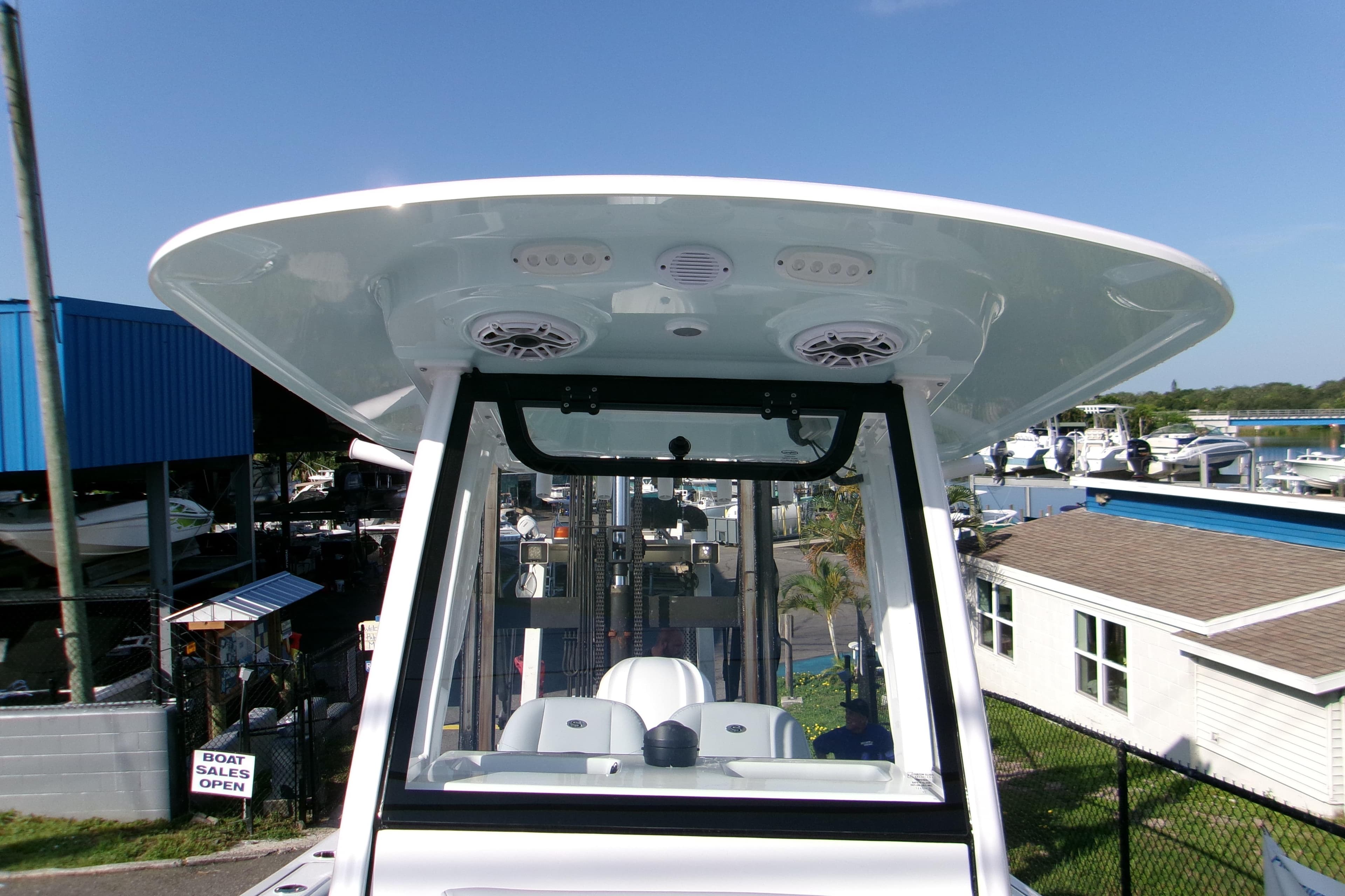 2026 Sportsman Heritage 231 Center Console boat at a marina, showcasing its helm and T-top.