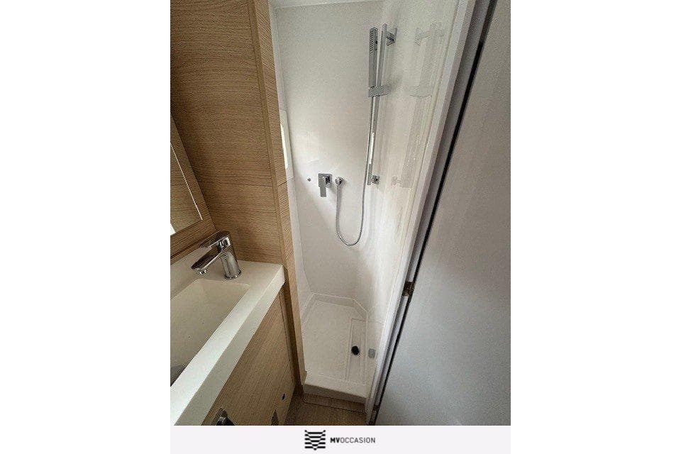 Modern bathroom in 2024 Aventura 37 yacht with sleek shower and sink.