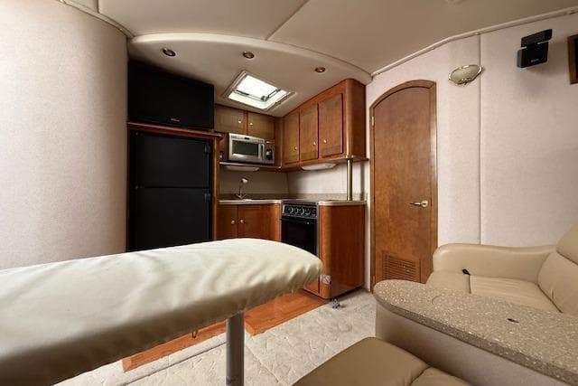 Interior of 2006 Rinker Fiesta Vee 410 yacht with kitchenette and seating area.