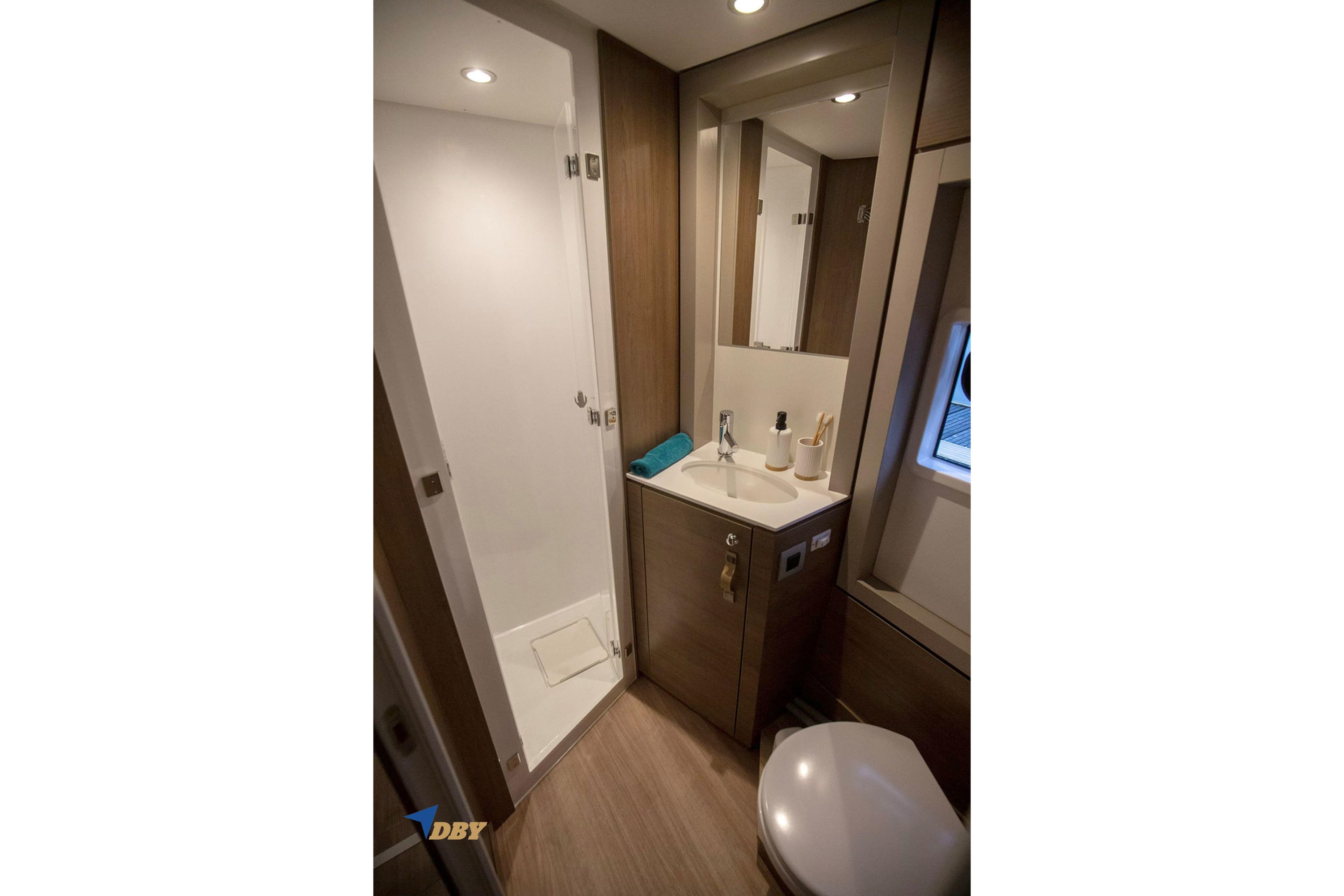 Modern bathroom in 2025 Bali 4.4 yacht with shower, sink, and toilet.