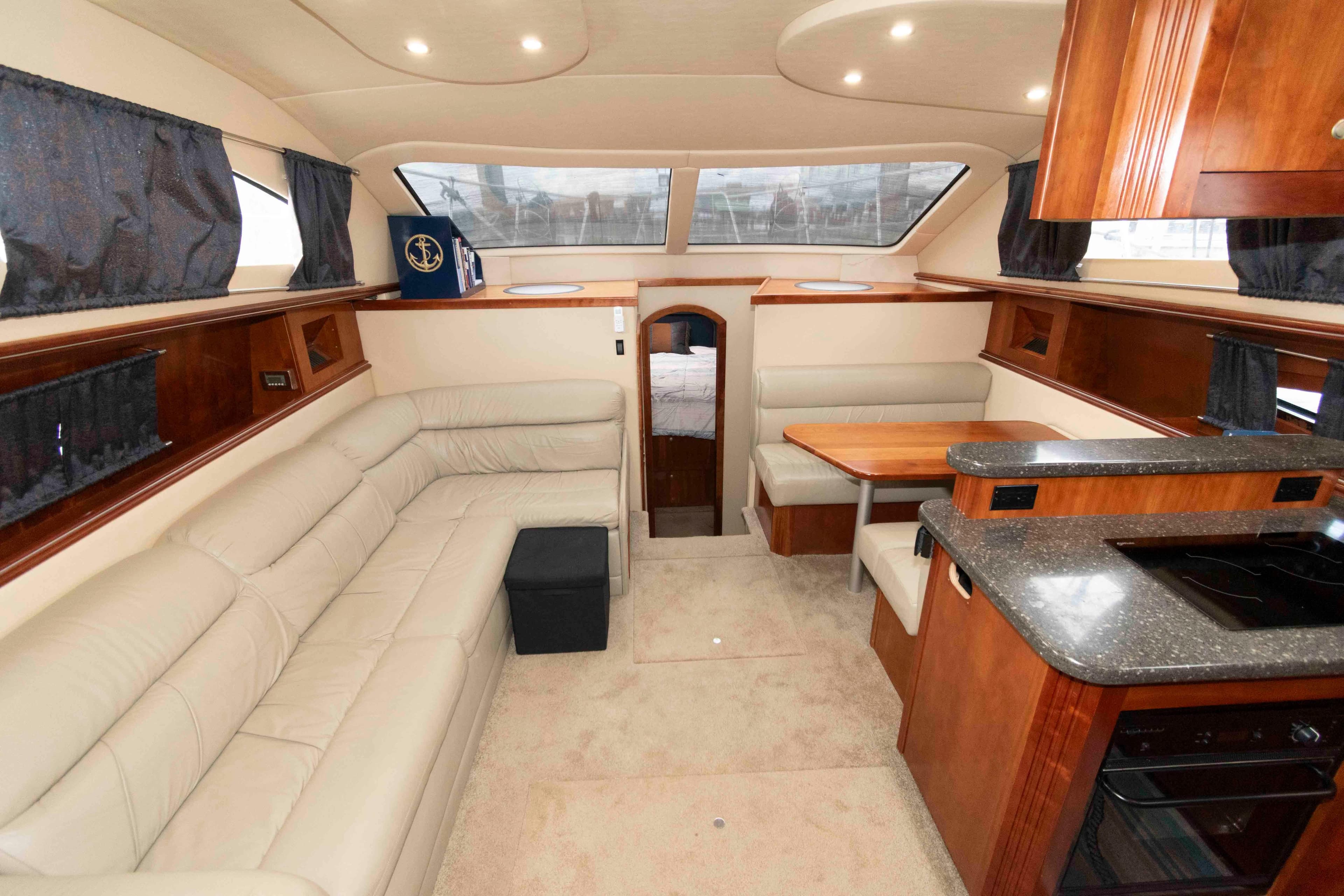 Luxurious interior of 2007 Cruisers Yachts 415 Express Motoryacht with plush seating and modern kitchen.