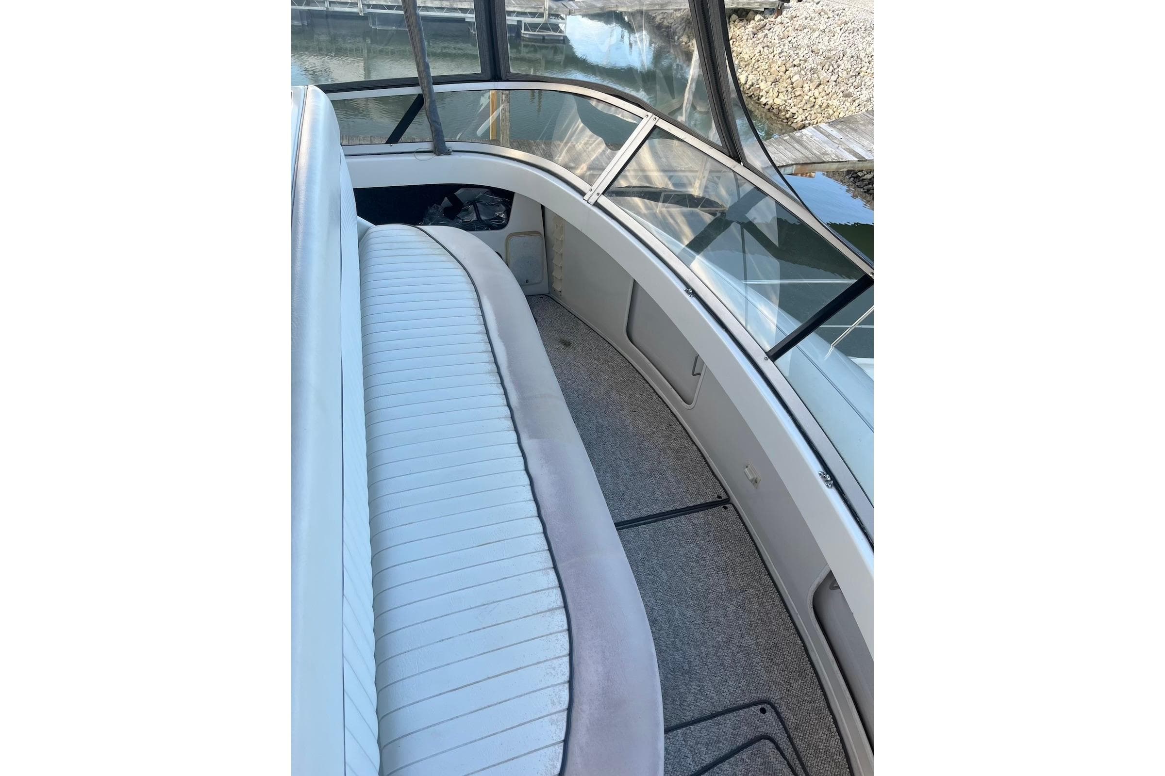 1993 Carver 350 Aft Cabin Motor Yacht interior with cushioned seating and windows.