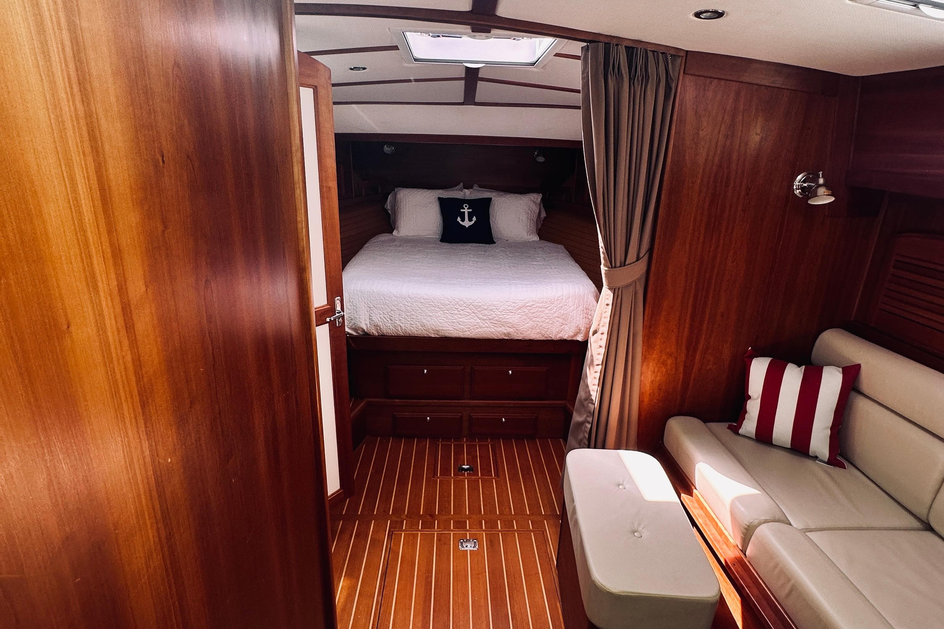Luxurious 2007 Sabreline 34 Express cabin interior with wood finish and cozy bedding.