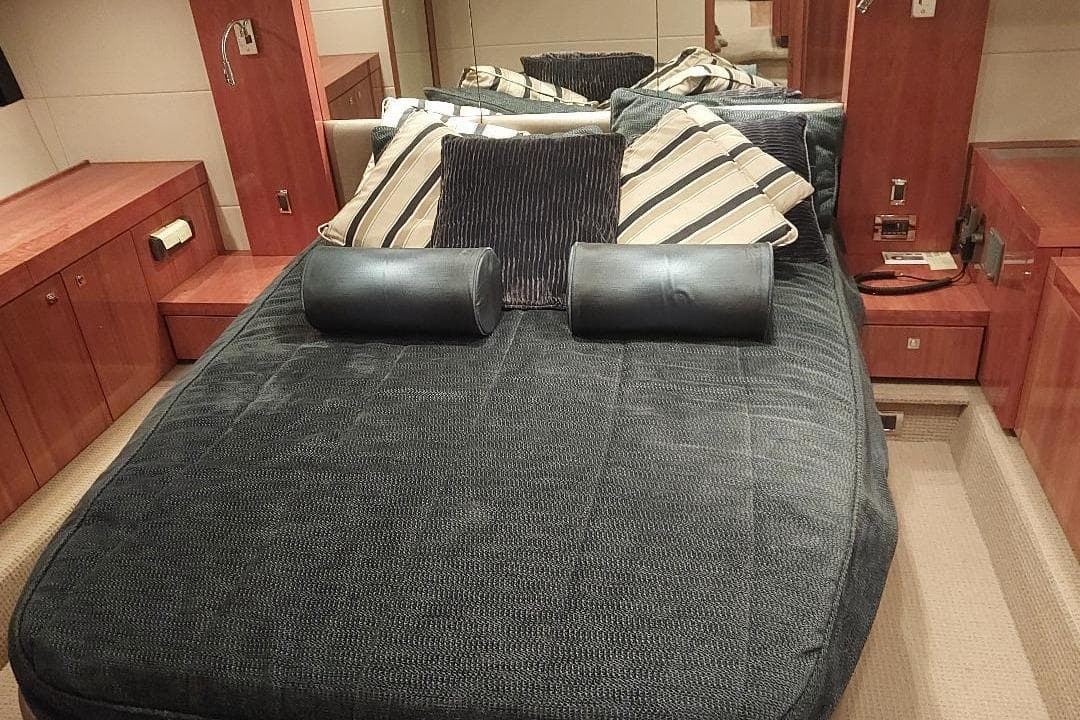 Luxurious cabin interior of 2012 Sunseeker Portofino 48 yacht with plush bedding.