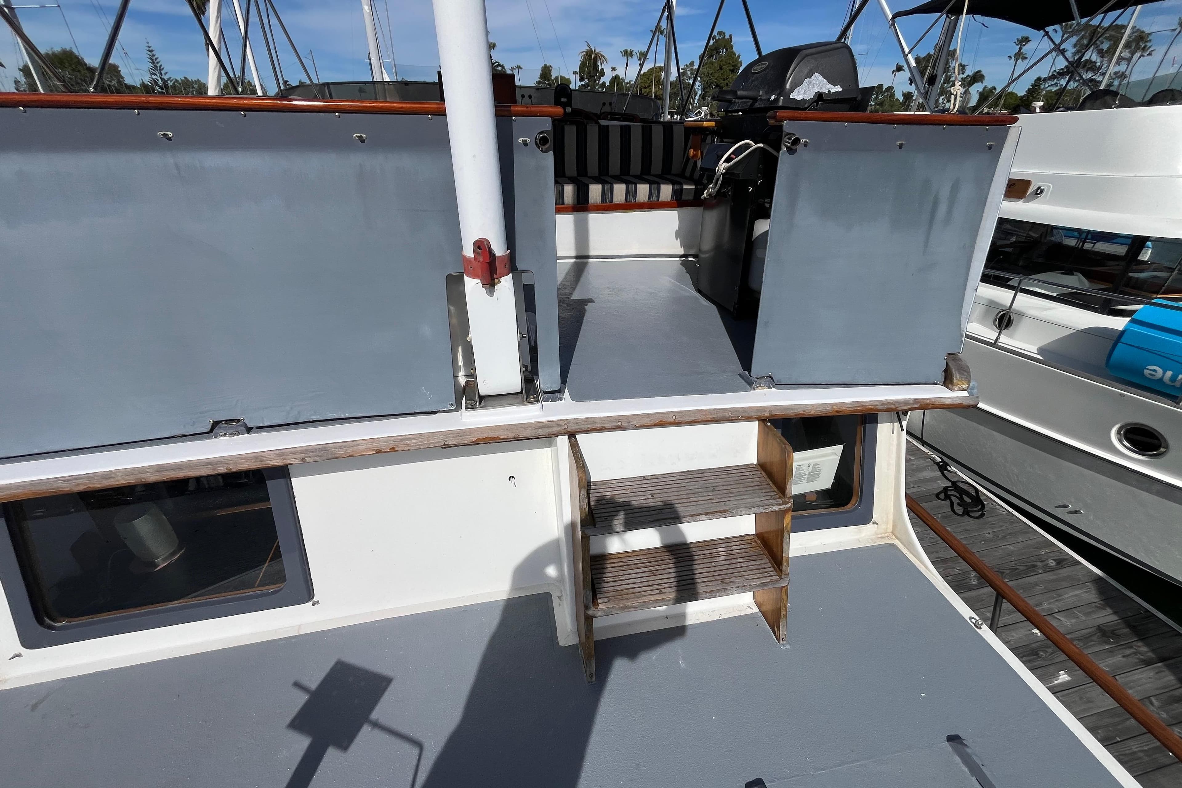 1978 Marine Trader 40 boat deck with steps and railing, docked at marina.
