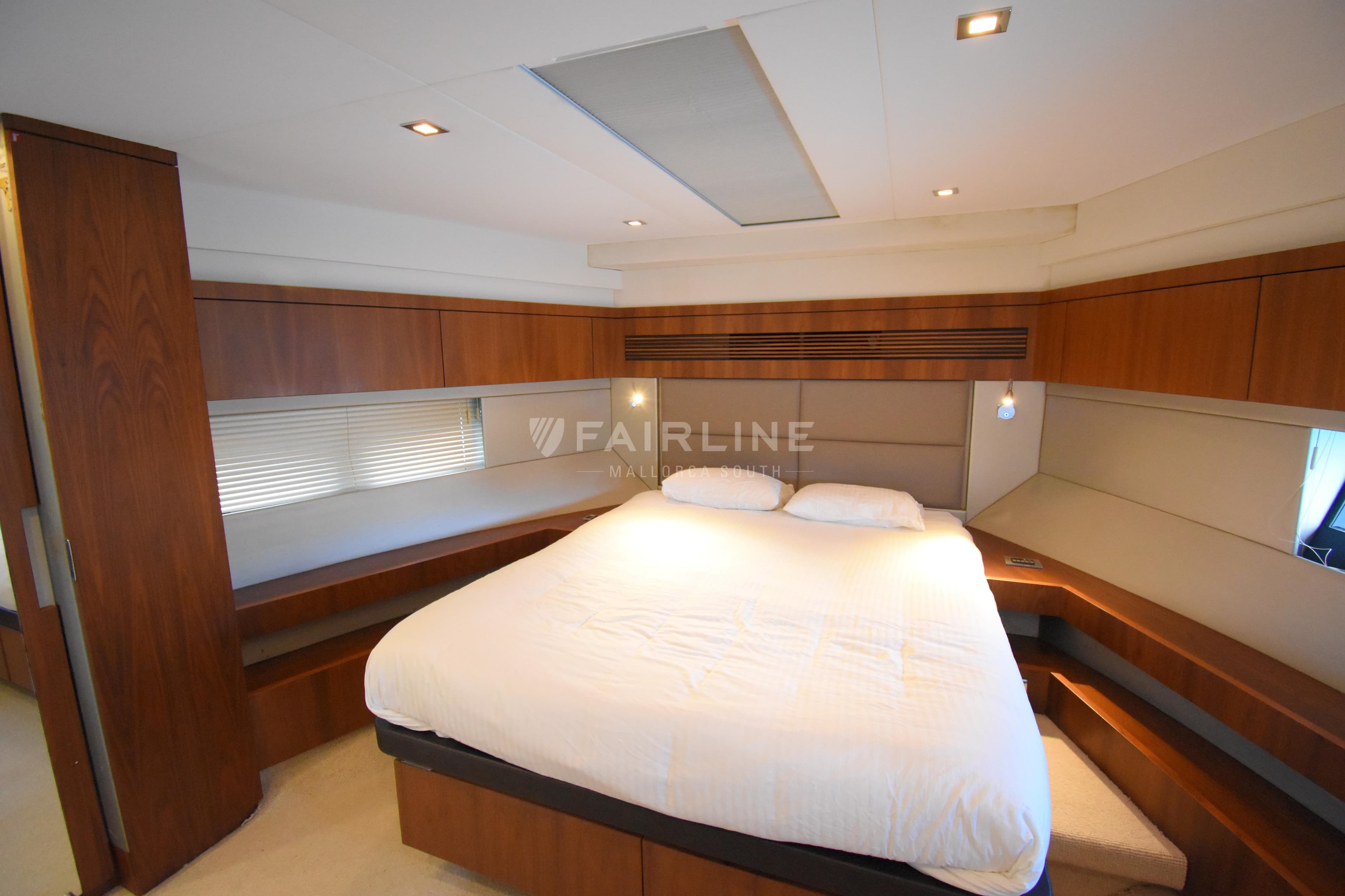 Luxurious bedroom interior of 2012 Fairline Targa 50 GT yacht with modern wood finishes.
