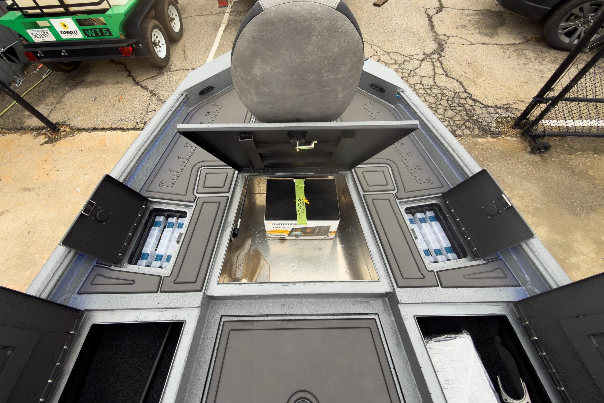 2026 Excel Bay Pro Elite 230 boat interior with storage compartments open.