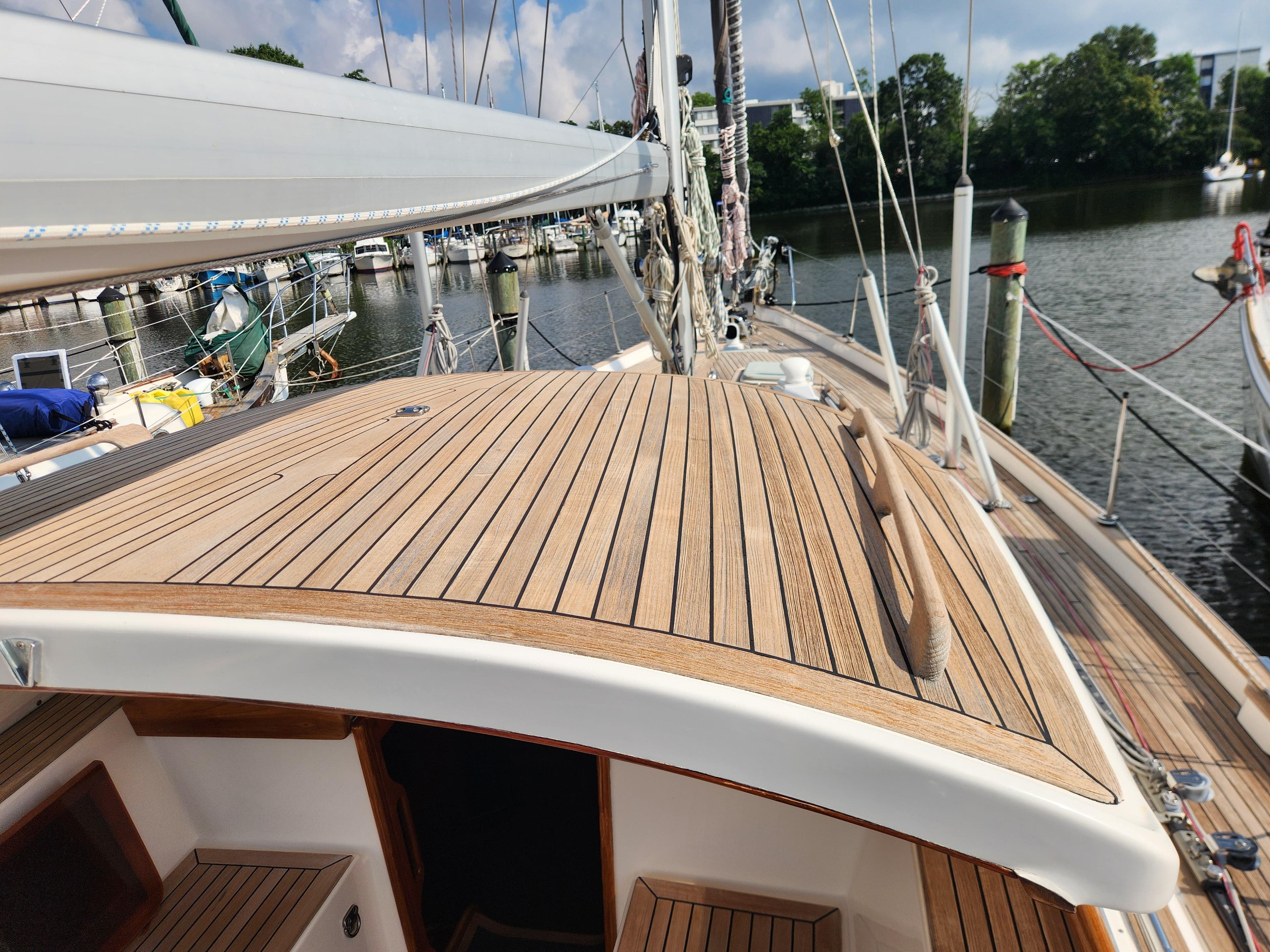 Hallberg-Rassy 48 sailboat deck, 2006 model, docked at a marina.