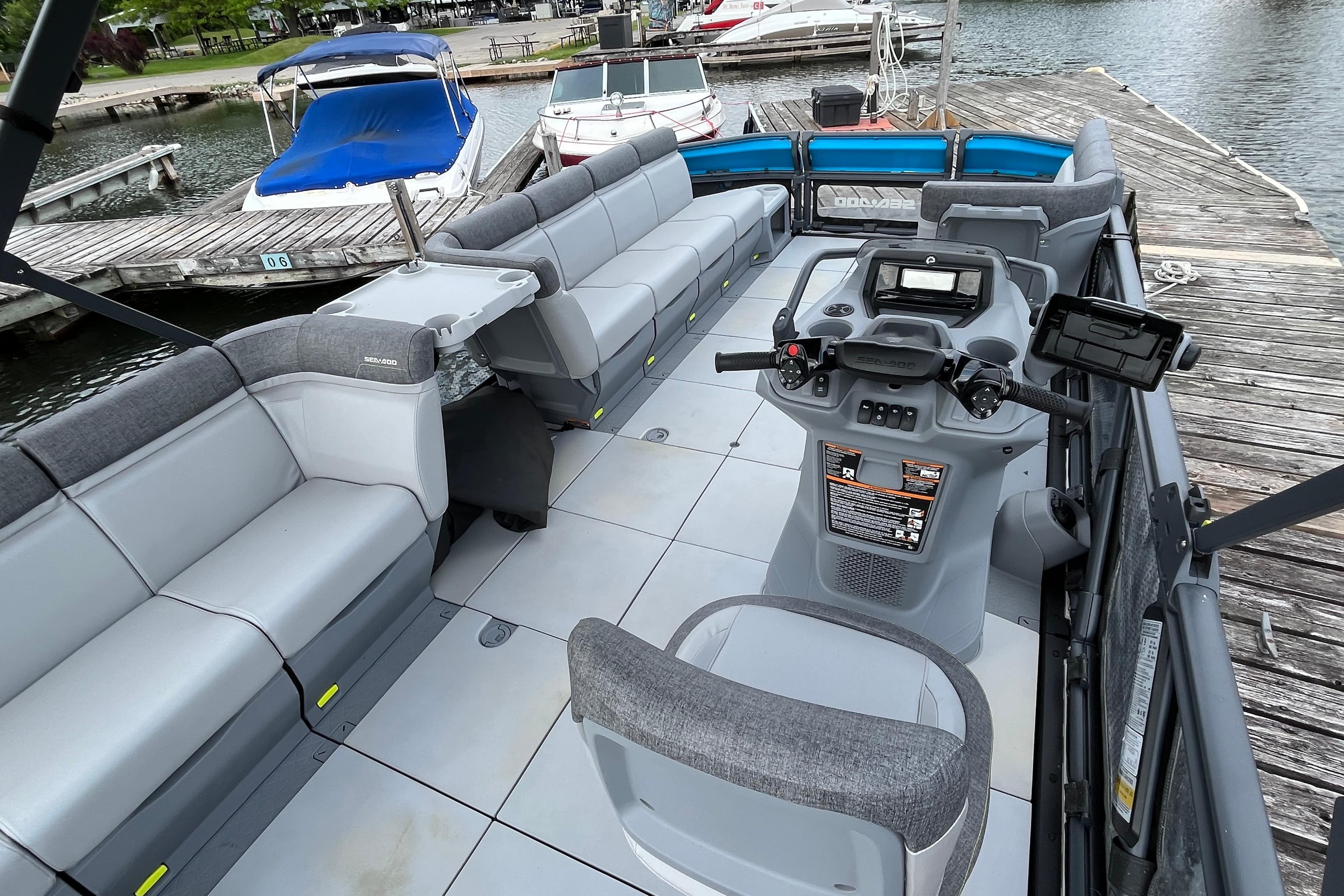 2023 Sea-Doo Switch Sport 21 interior with spacious seating and modern controls at a dock.