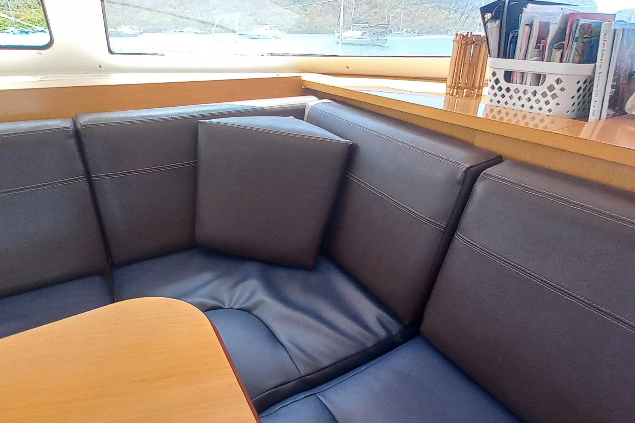 Interior of 2010 Fountaine Pajot Lipari 41 catamaran with cushioned seating and table.