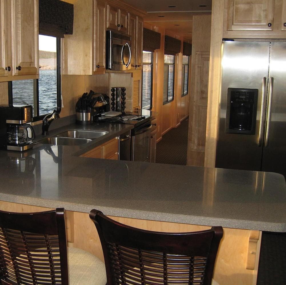 Luxurious kitchen interior of 2009 Sumerset Stargazer Trip 10 houseboat with modern appliances.
