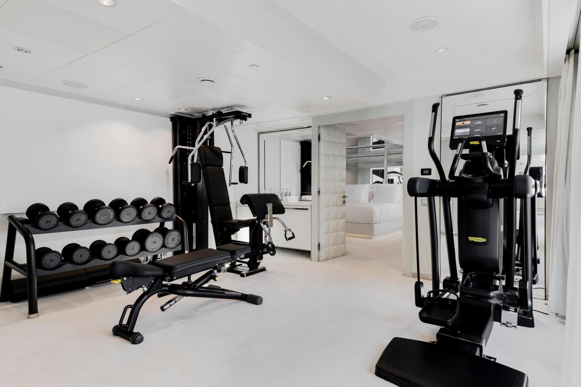 Luxurious yacht gym with modern equipment, featuring weights and exercise machines, Austal Displacement 2007.