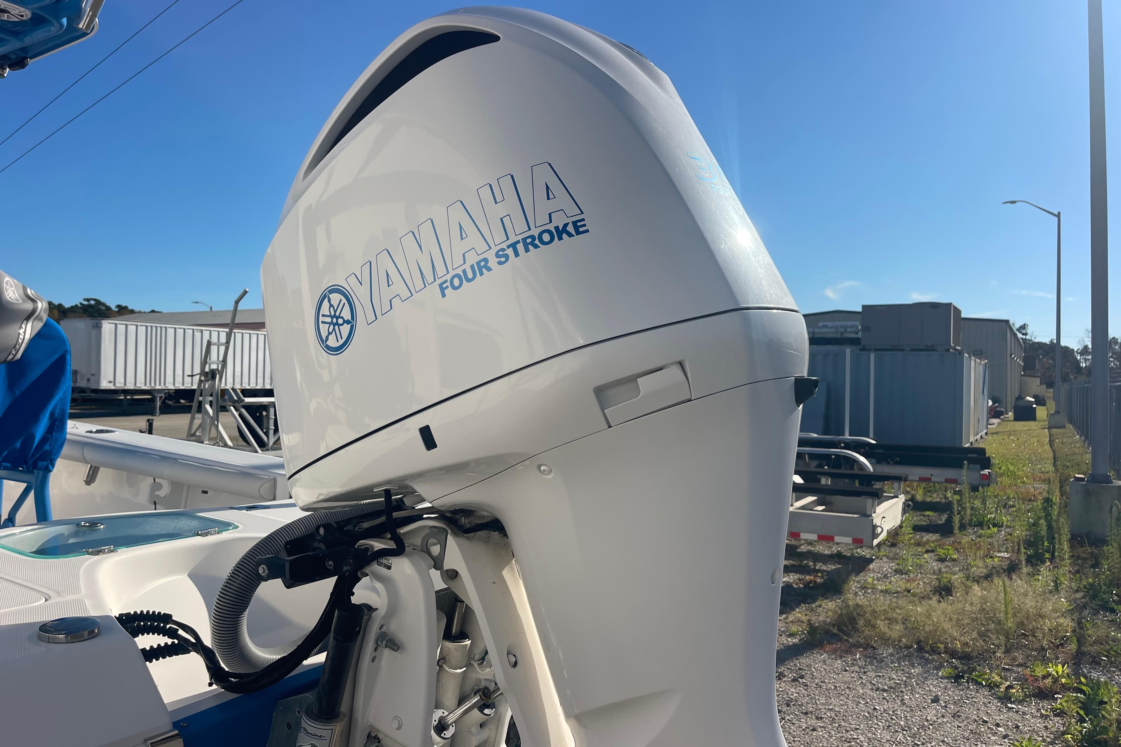 2021 Everglades 243 Center Console with Yamaha Four Stroke engine in a sunny outdoor setting.
