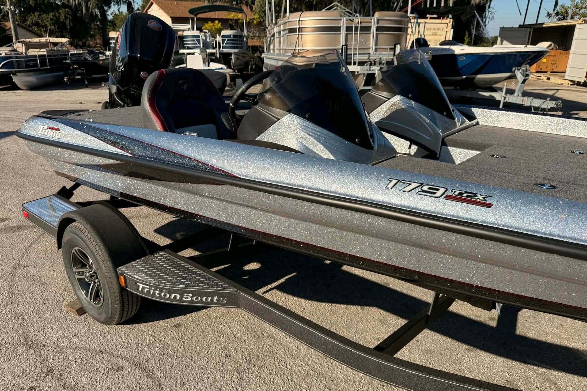 2026 Triton 179 TrX boat on trailer, silver finish, parked outdoors.