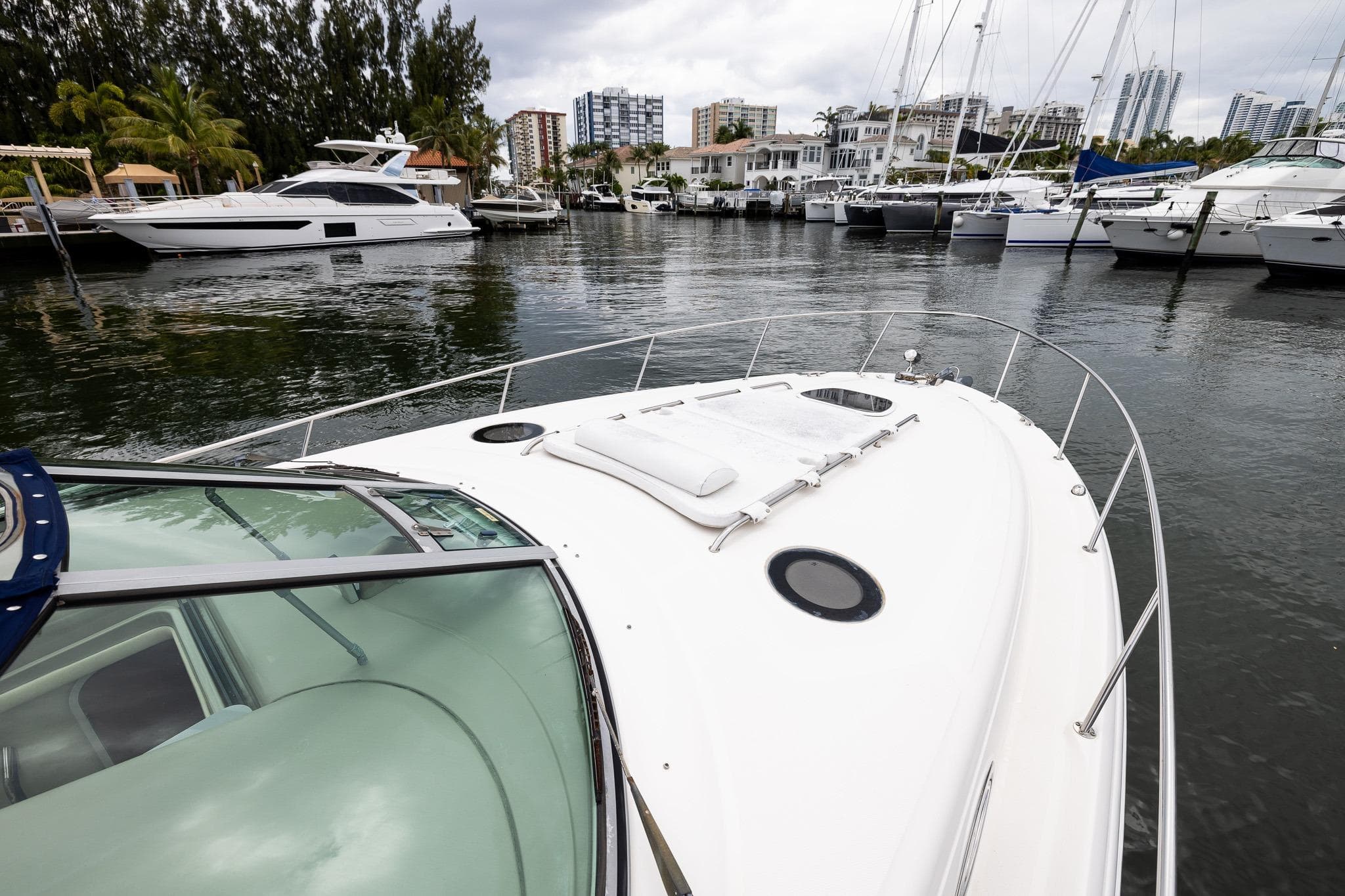 2007 Sea Ray 340 Sundancer yacht docked in a marina with surrounding boats.