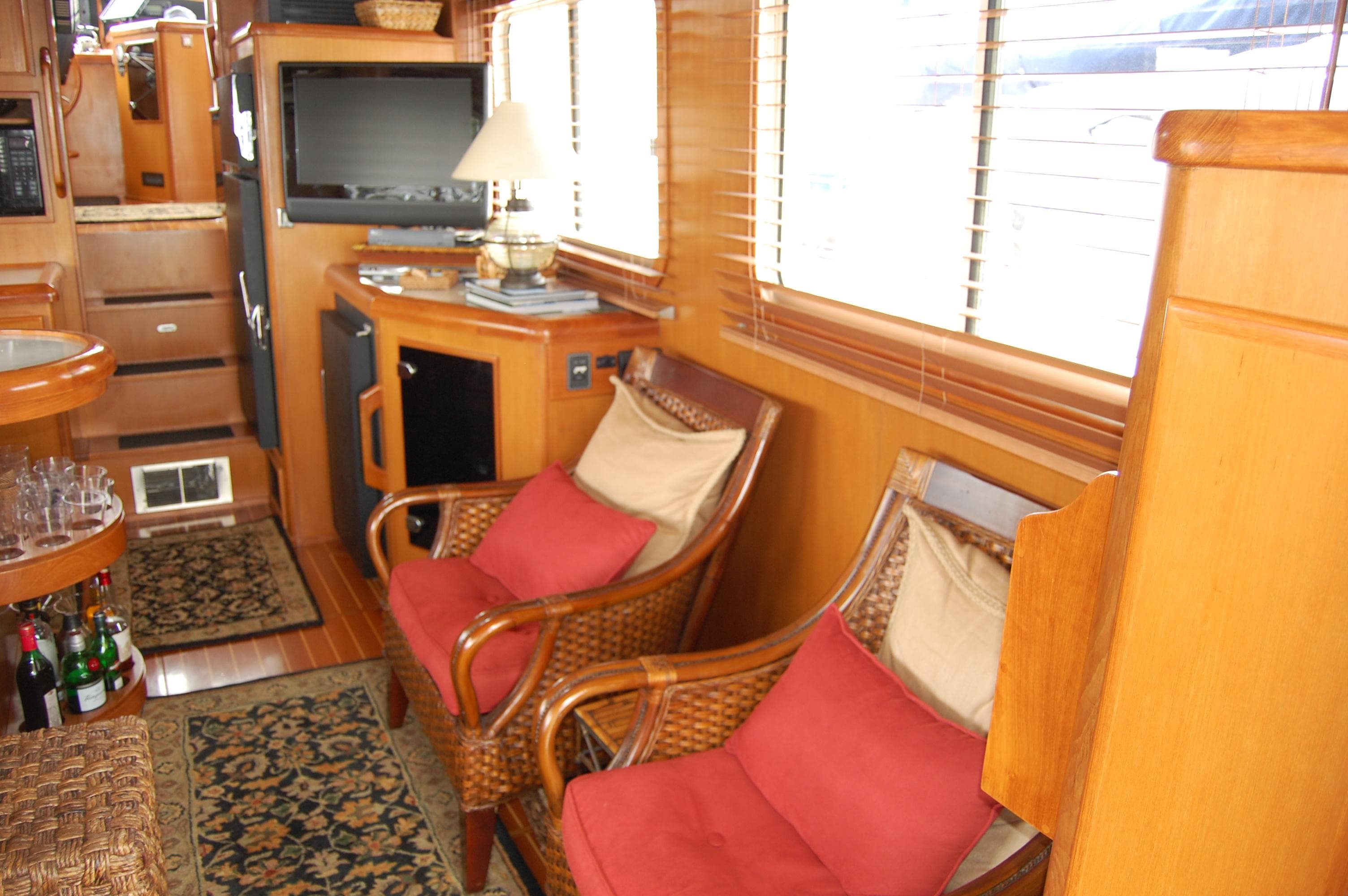 Interior of 2002 Eagle Pilothouse with cozy seating, TV, and wooden decor.