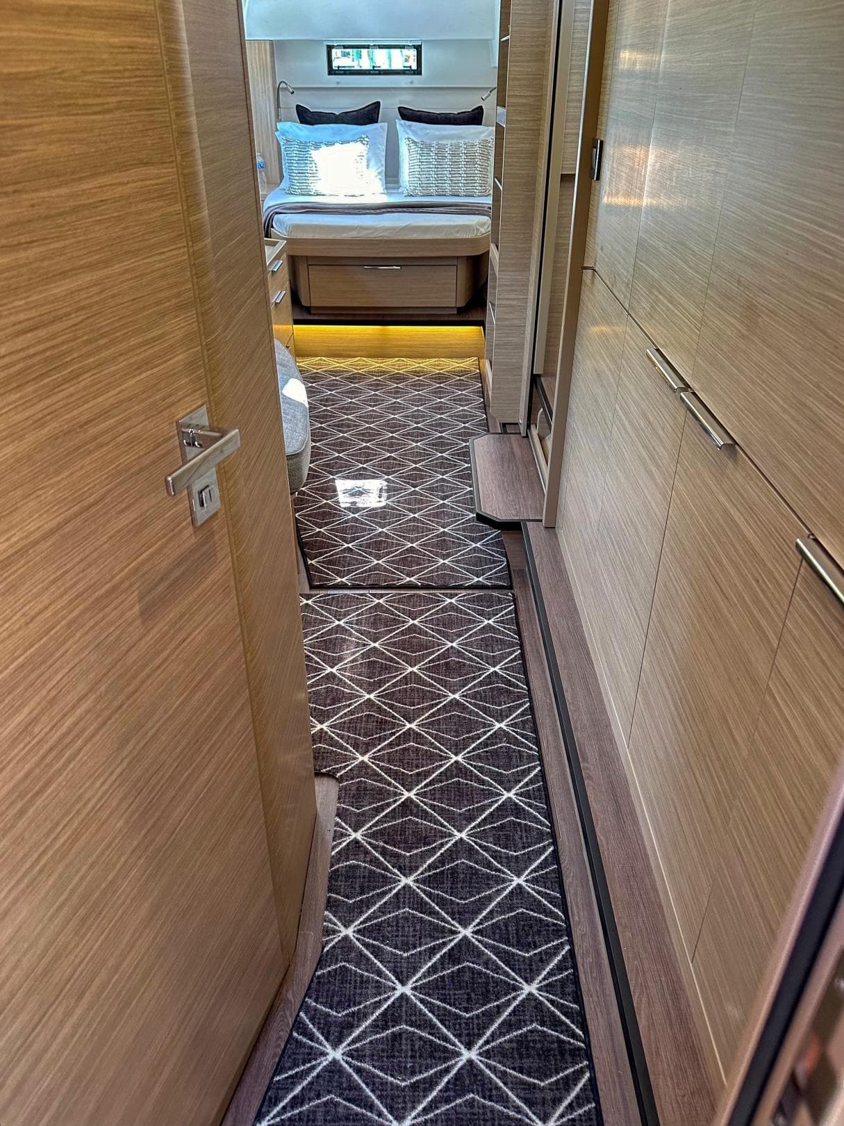 2024 Lagoon 46 yacht interior hallway with modern design and elegant bedroom view.