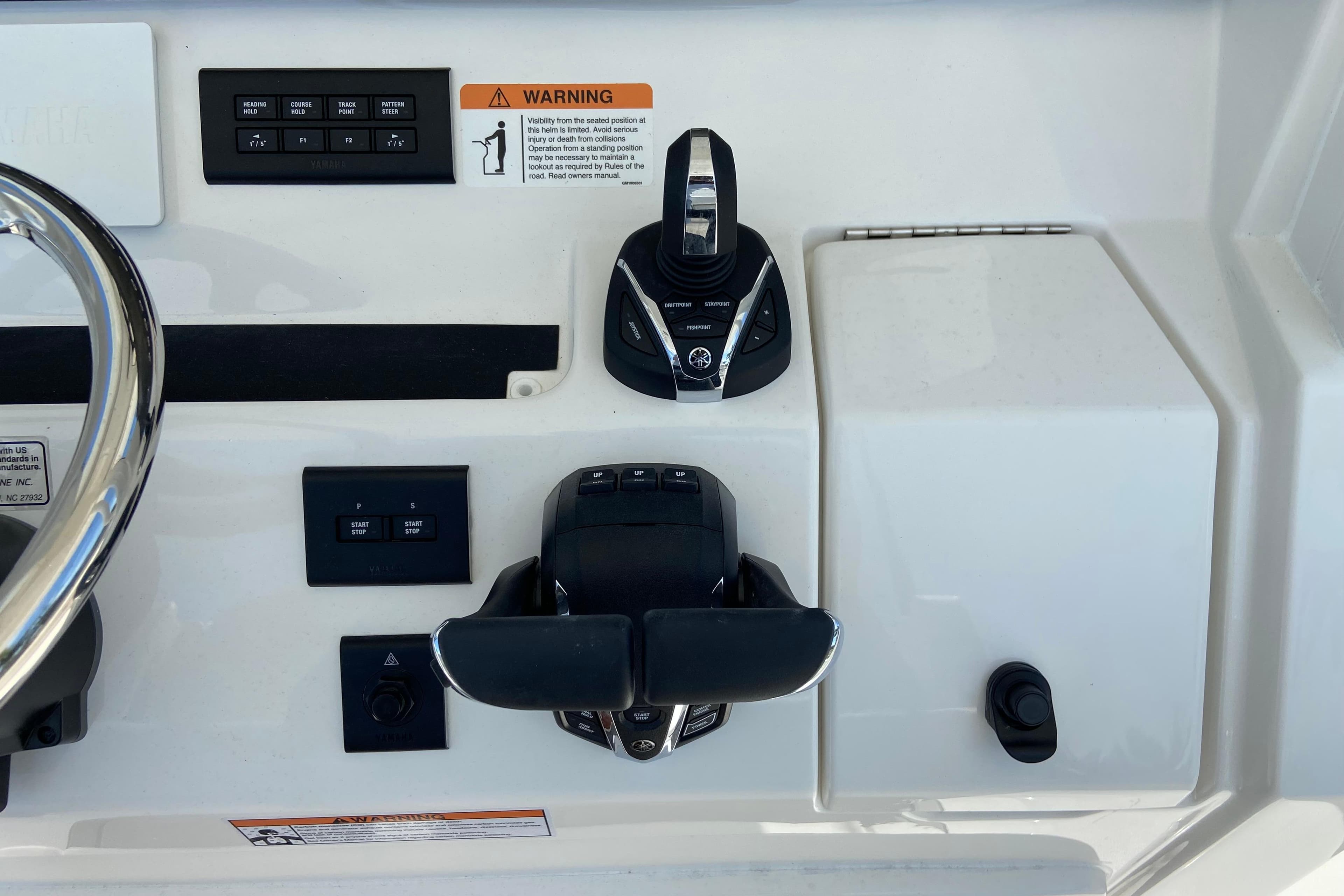 Control panel of a 2026 Regulator 31 boat with steering and throttle controls.