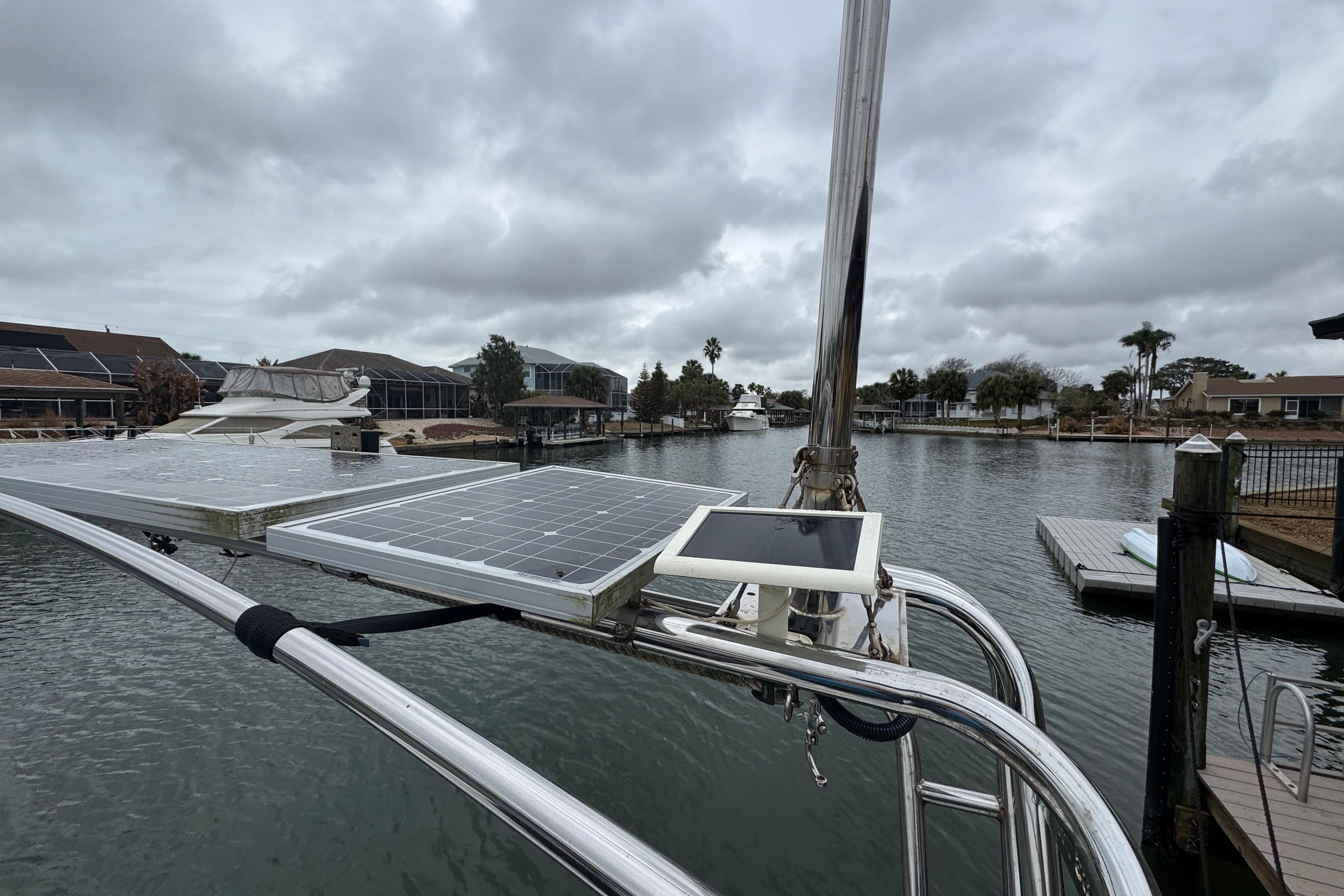 2004 Alliaura FEELING 44 DI sailboat with solar panels on a cloudy day by the water.