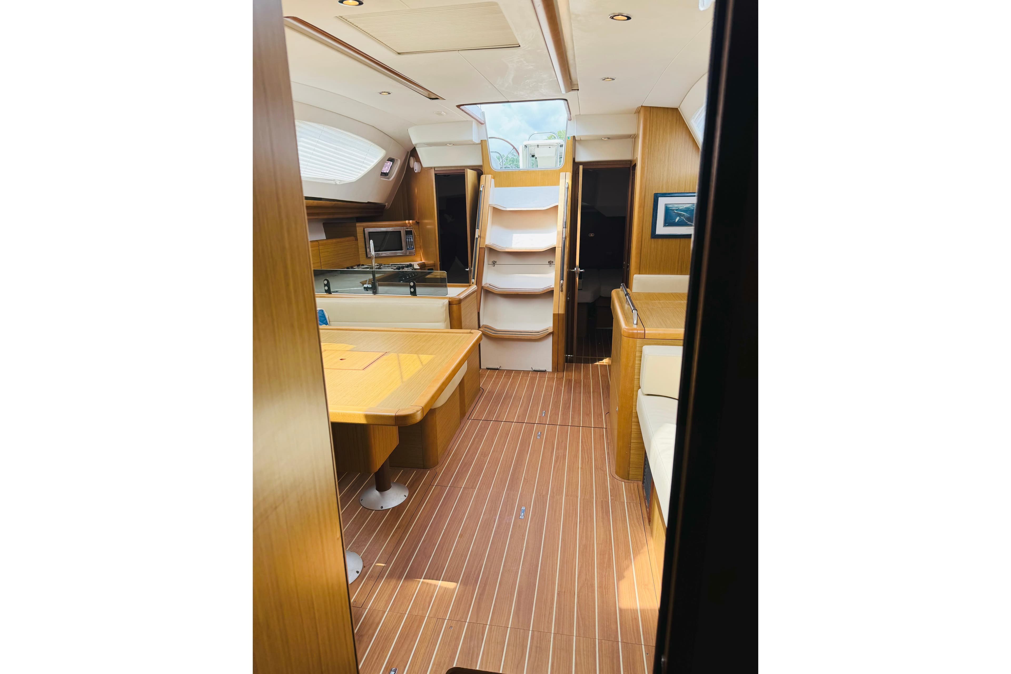 Interior of 2008 Jeanneau Sun Odyssey 45 DS sailboat, featuring wood finishes and modern amenities.