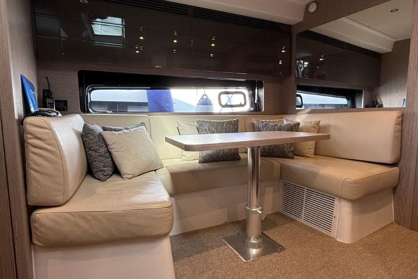 Luxurious interior of 2023 Azimut Atlantis 45 yacht with elegant seating and table.