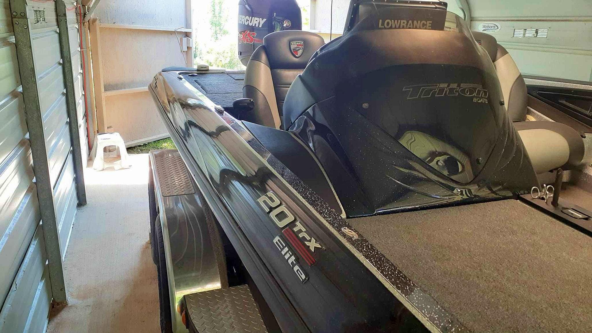 2016 Triton 20 TRX Elite boat in garage, featuring Lowrance equipment.