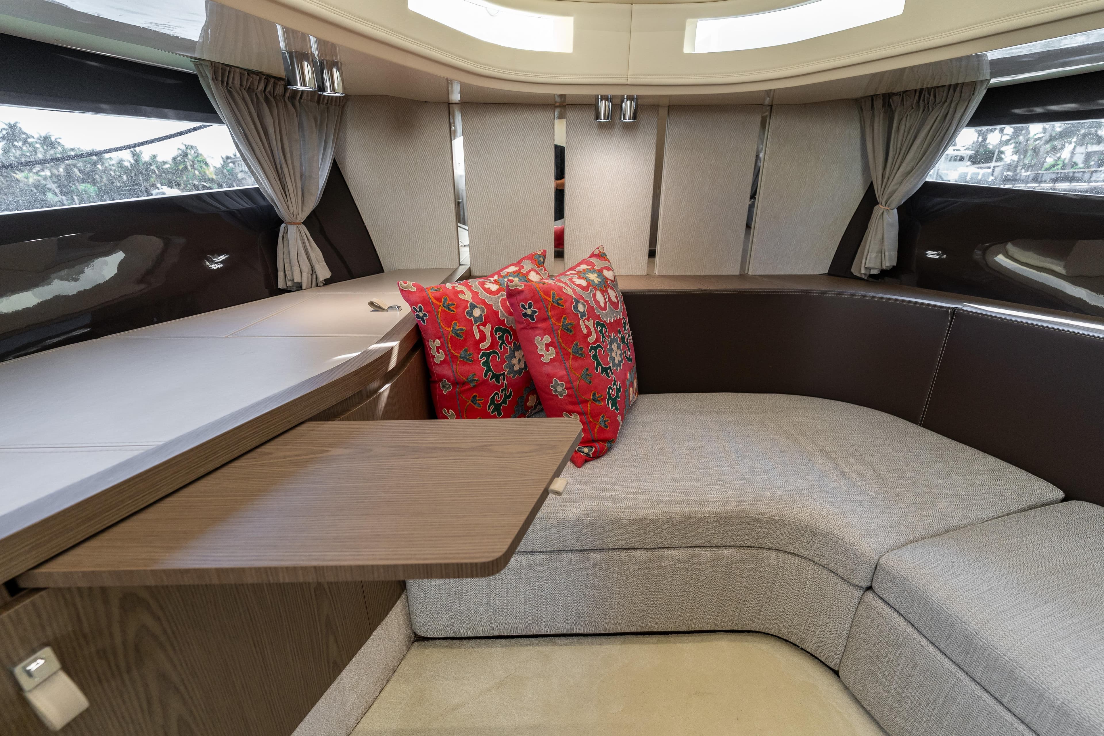 Luxurious interior of 2024 Invictus 460 yacht with elegant seating and vibrant cushions.