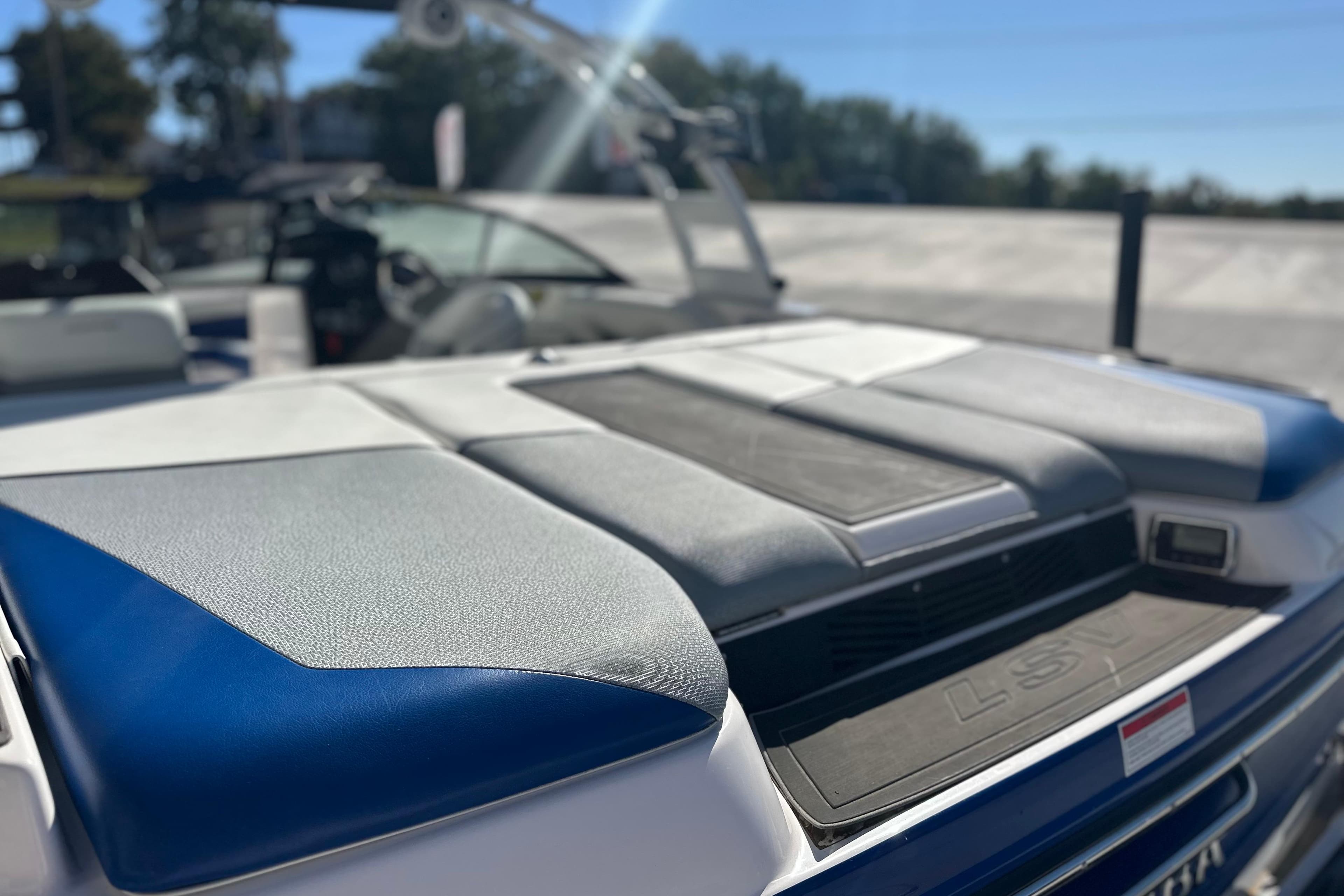 2015 Moomba Mobius LSV boat with blue and gray seating, sunny day.