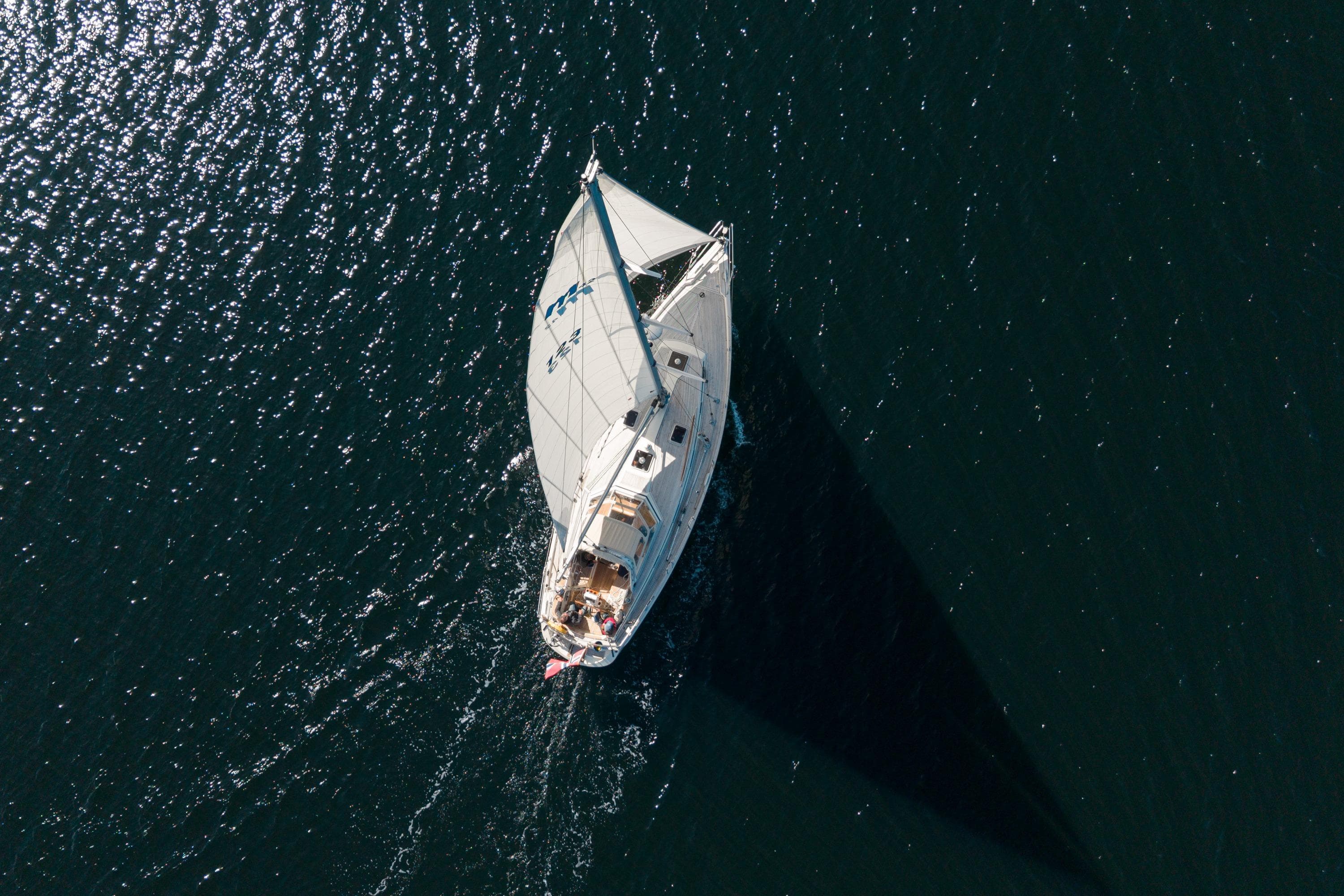 Aerial view of a 1997 Malo 42 sailboat navigating on dark blue water.