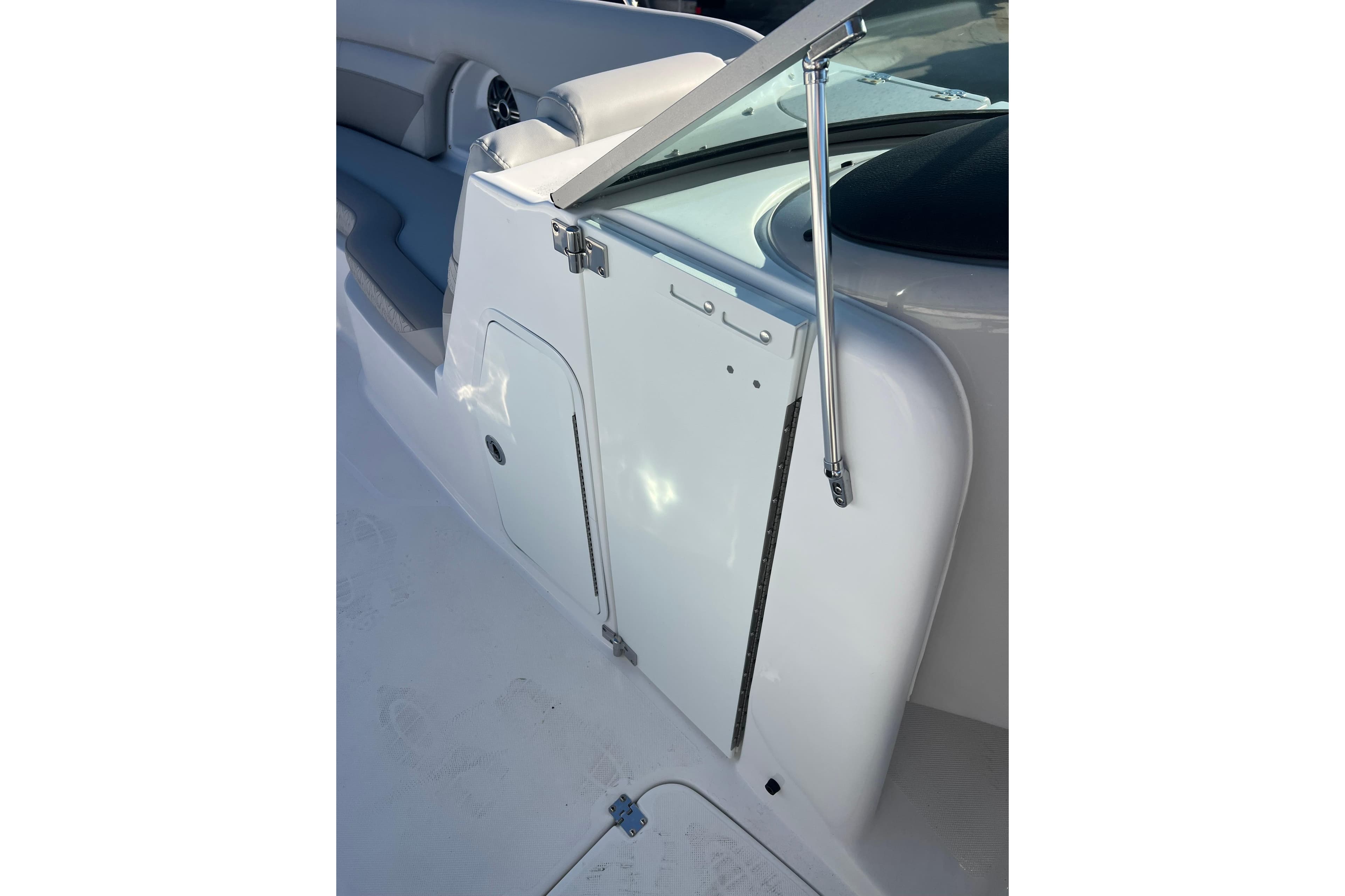 2026 Hurricane SunDeck 2486 OB boat interior with seating and storage compartment.