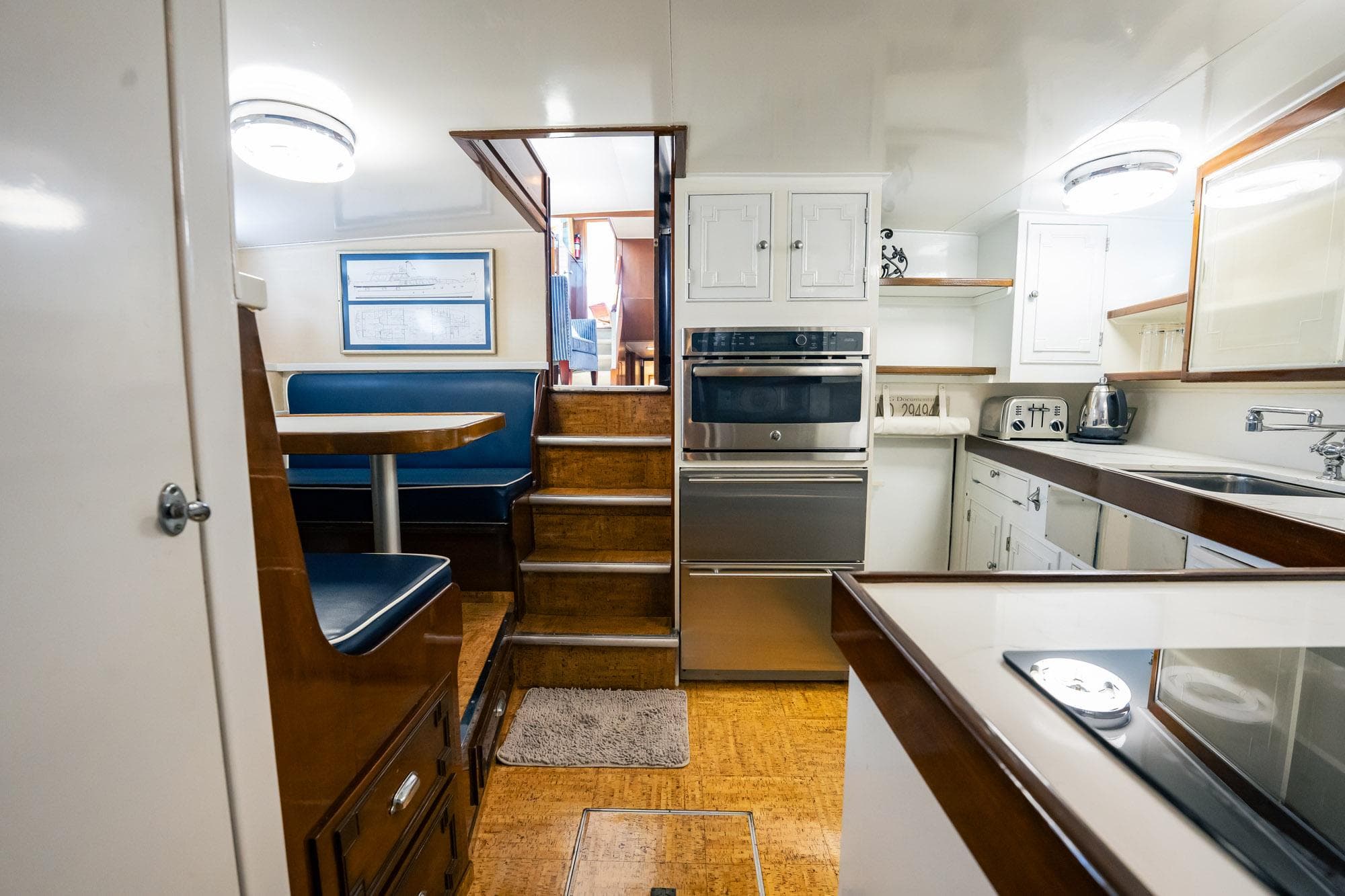 Interior of a 1964 Burger 64' Motor Yacht featuring a kitchen and dining area.