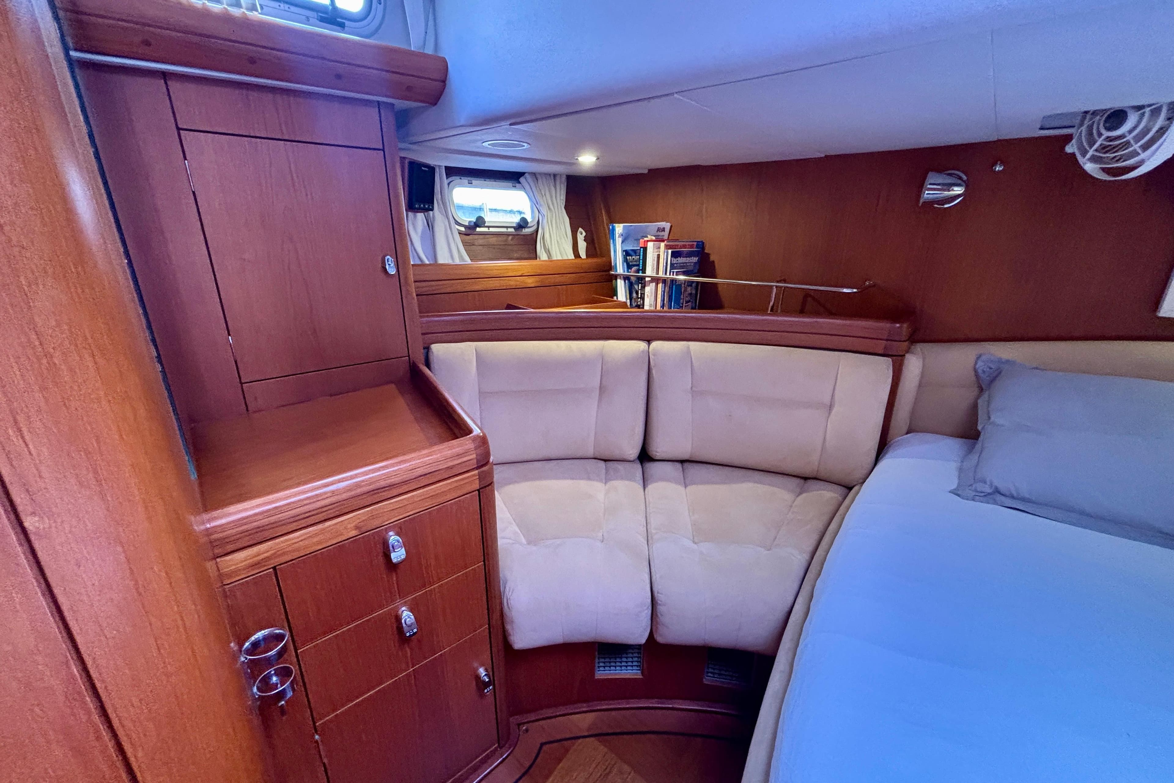 Luxurious cabin interior of a 2003 Oyster 56 yacht with plush seating and wooden cabinetry.