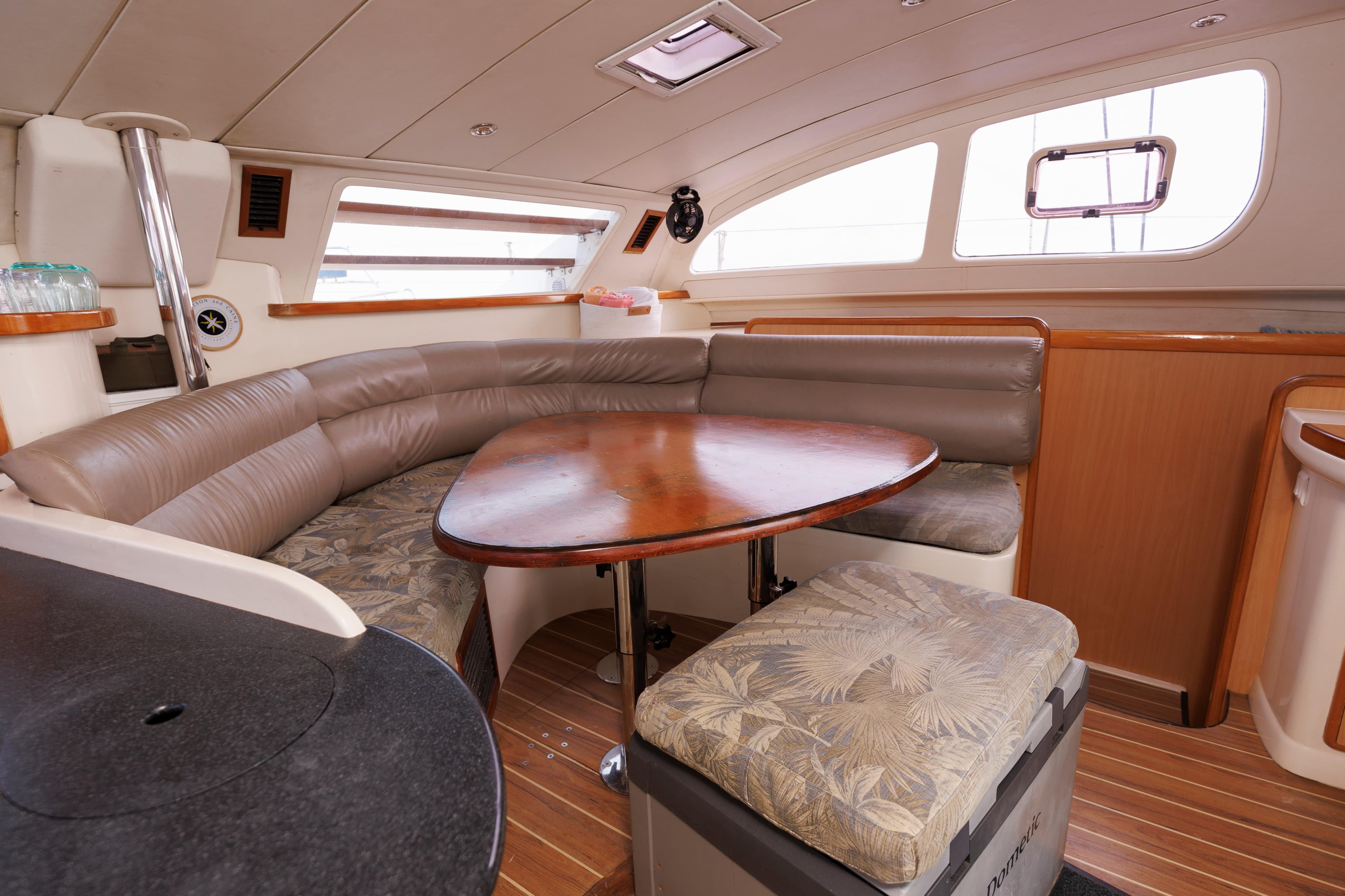 Luxurious interior of a 2006 Leopard 43 yacht with elegant seating and wooden table.