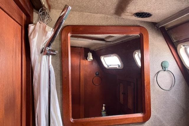 Interior of 1981 S2 11.0A sailboat with wooden cabinetry and porthole windows.