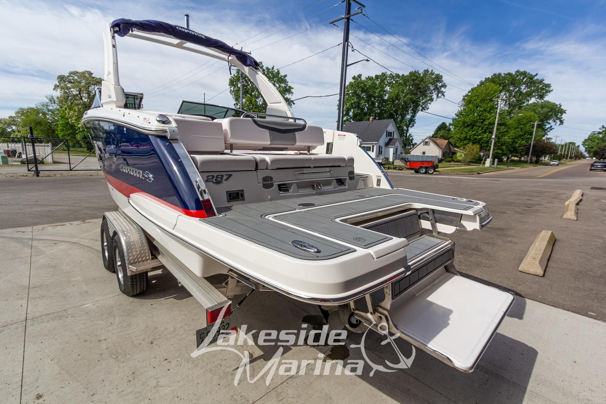 2021 Chaparral 287 SSX boat on trailer at Lakeside Marina, showcasing rear deck and seating.