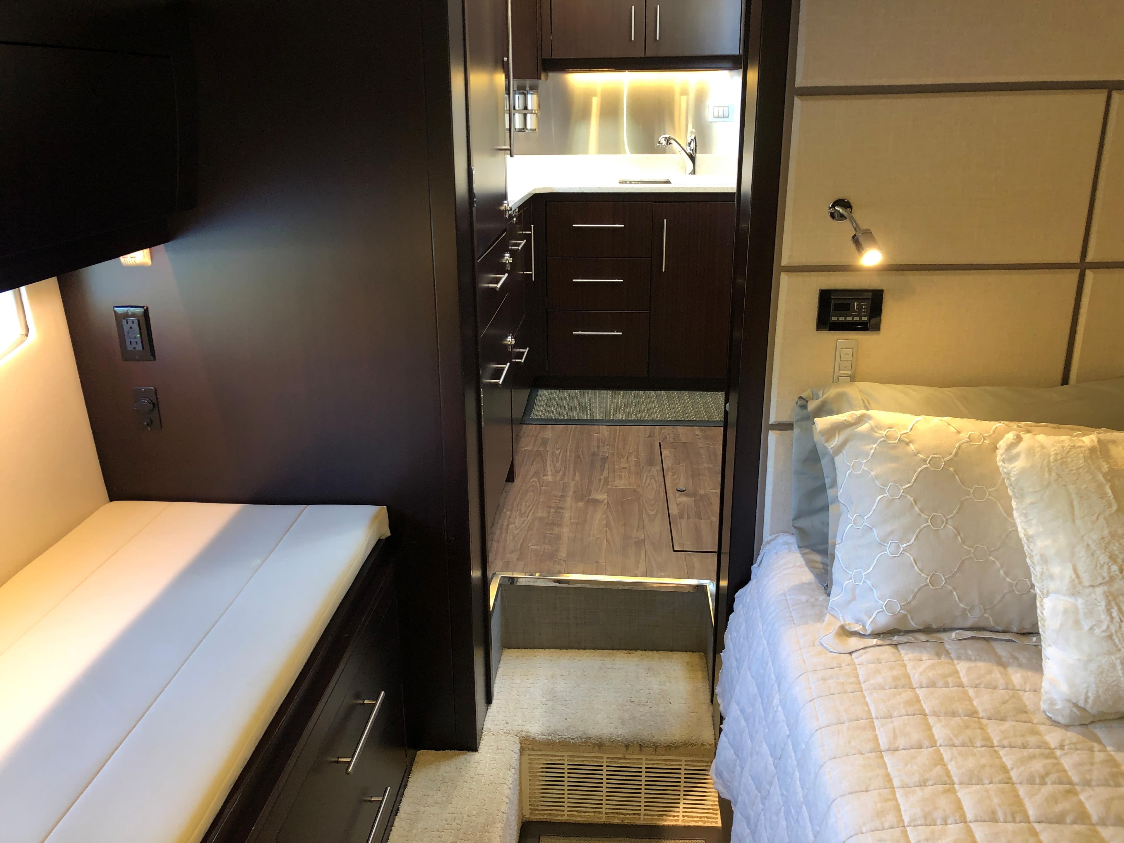 Interior of 2017 Regal 53 Sport Coupe with modern kitchen and cozy bedroom.