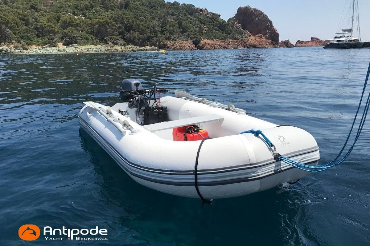 Inflatable boat Pogo 1250 (2015) anchored in scenic coastal waters.