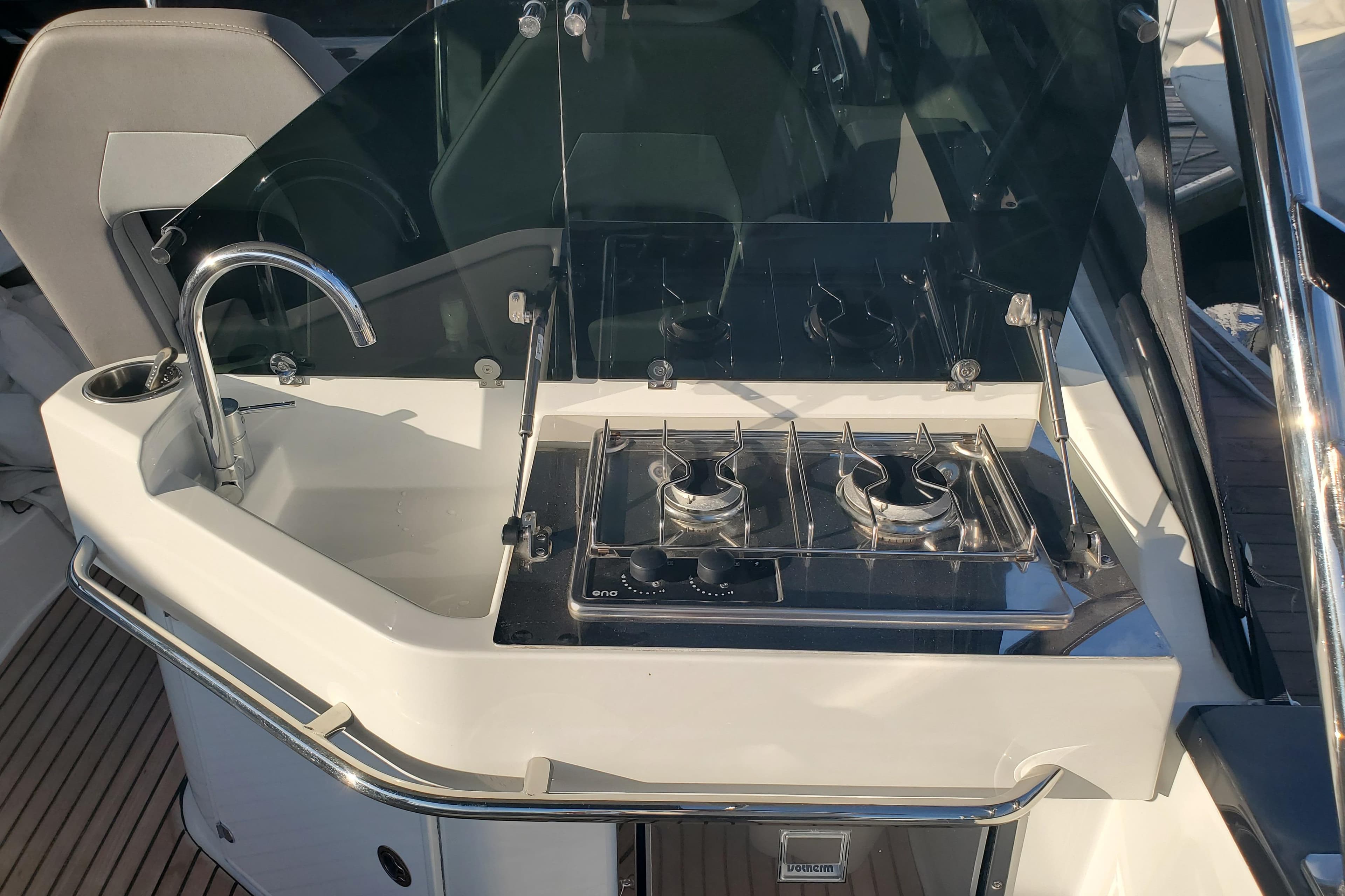 2021 Beneteau Flyer 10 boat kitchen with sink and dual-burner stove.