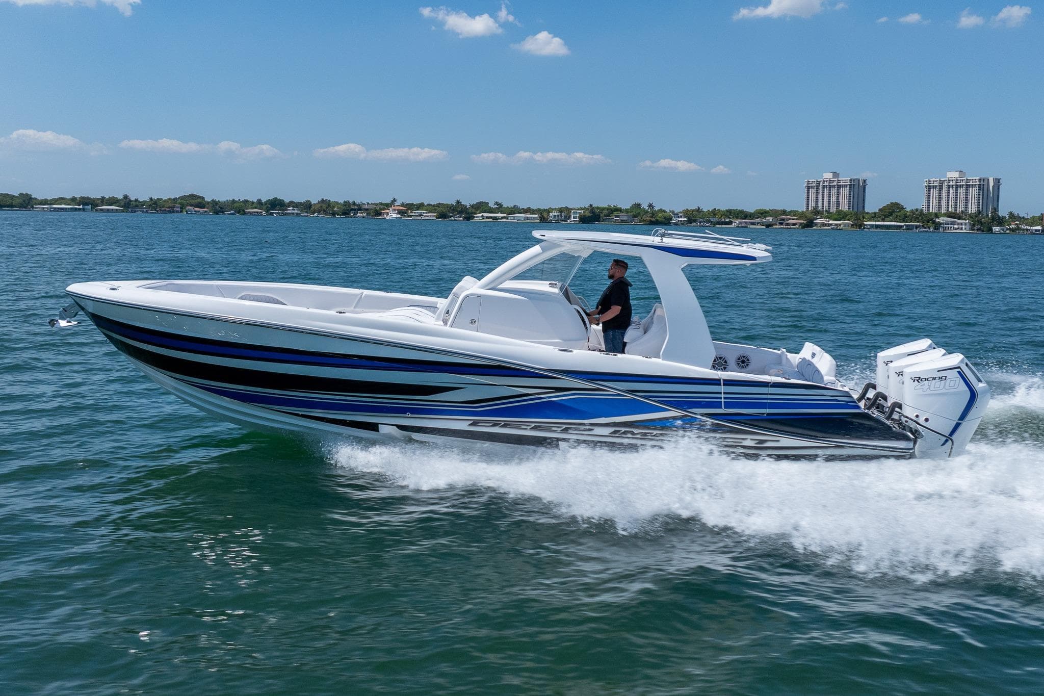 2026 Deep Impact 369 Sport boat cruising on water.
