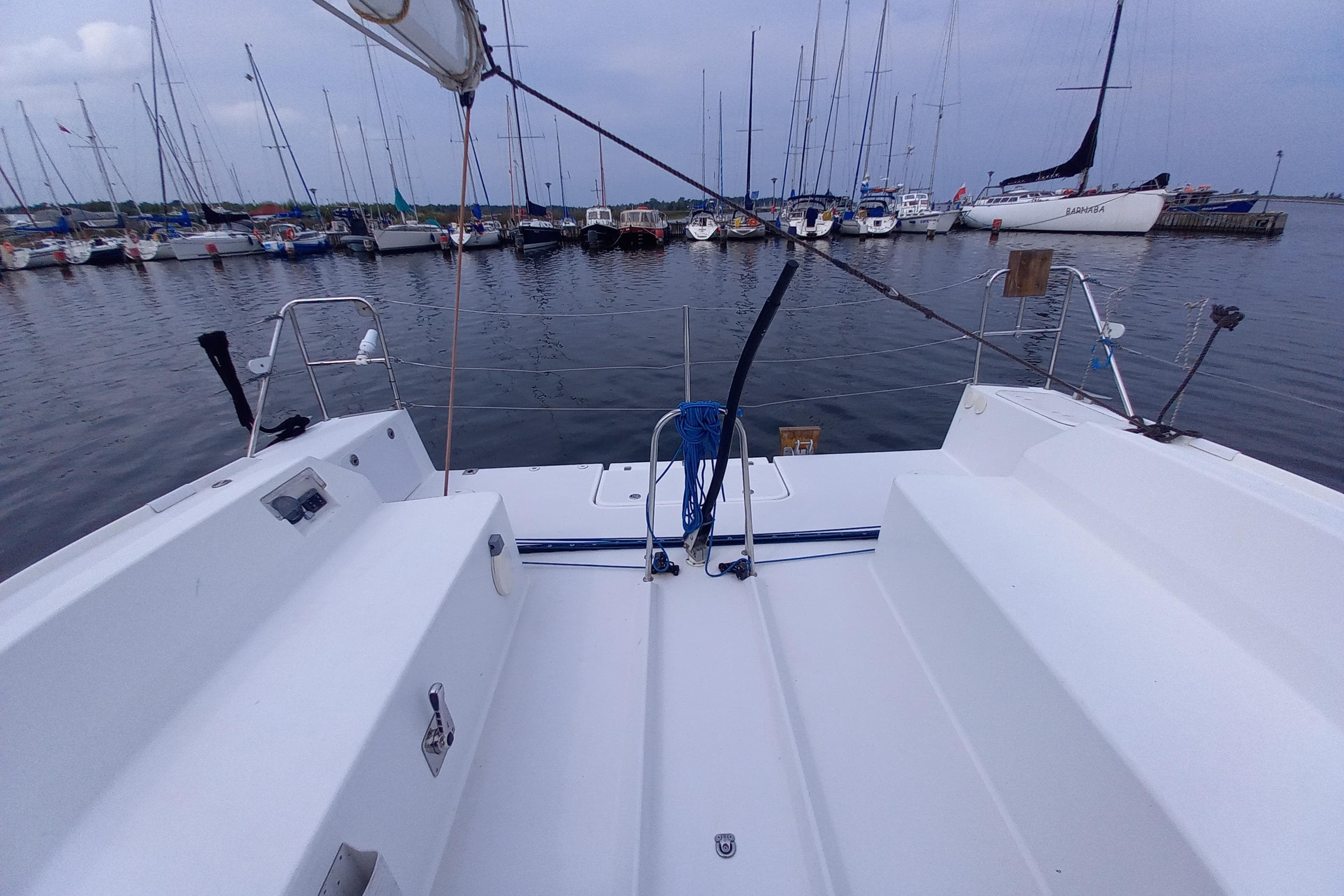 Sailboat Pogo 12.50 (2017) docked in marina, surrounded by other boats.