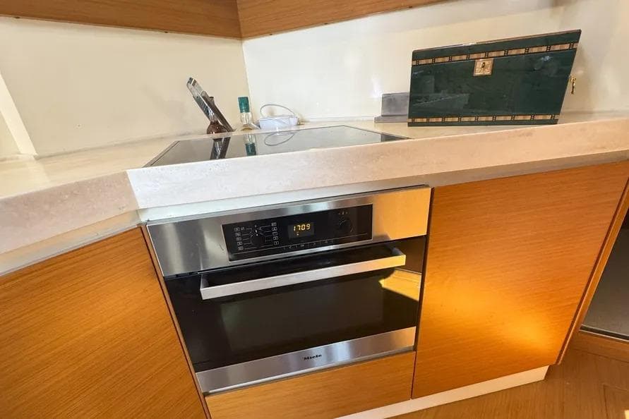 Modern kitchen in 2014 Azimut 45 yacht with sleek appliances and wooden cabinetry.