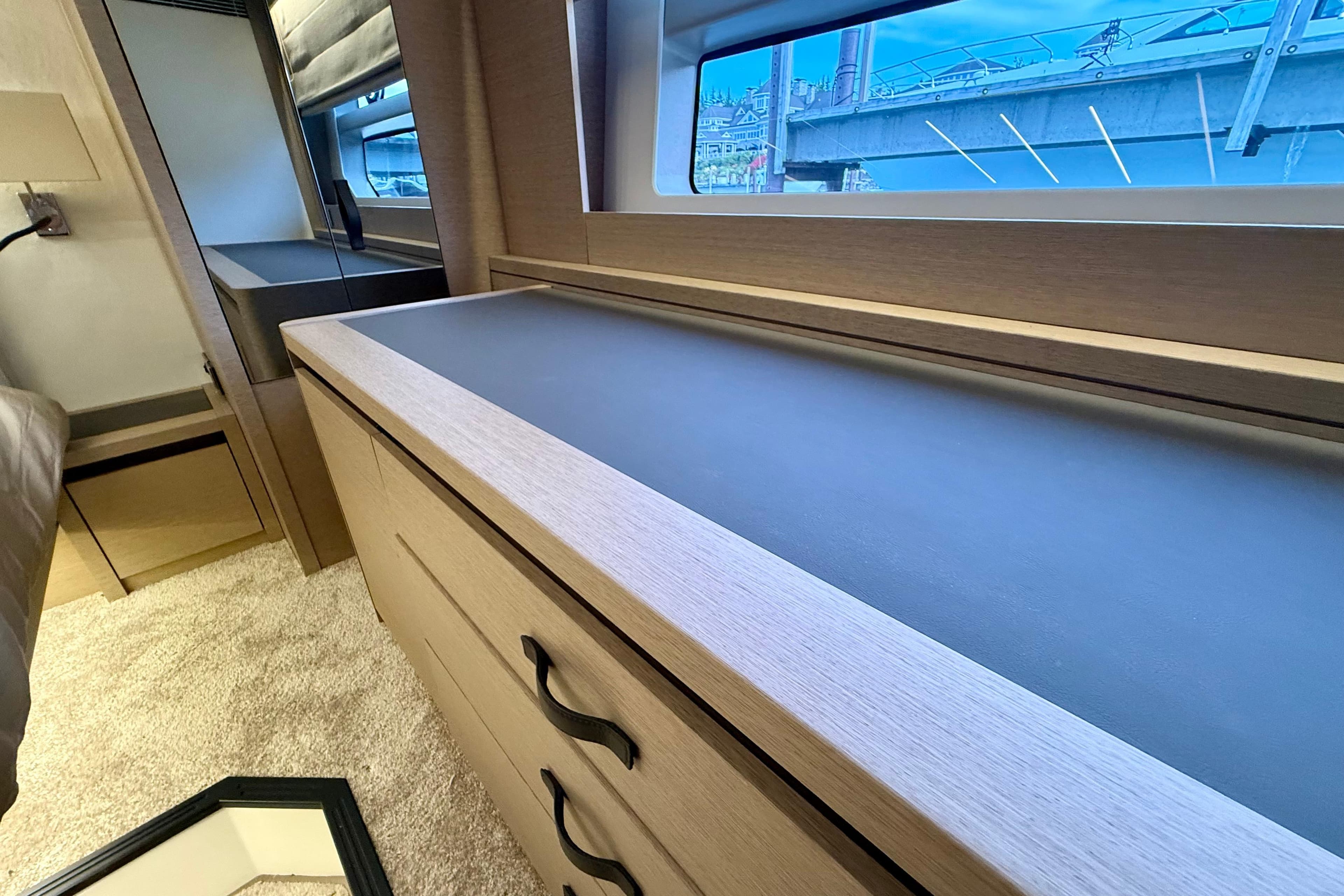 Luxurious interior of 2020 Prestige 590 yacht with sleek cabinetry and large window view.