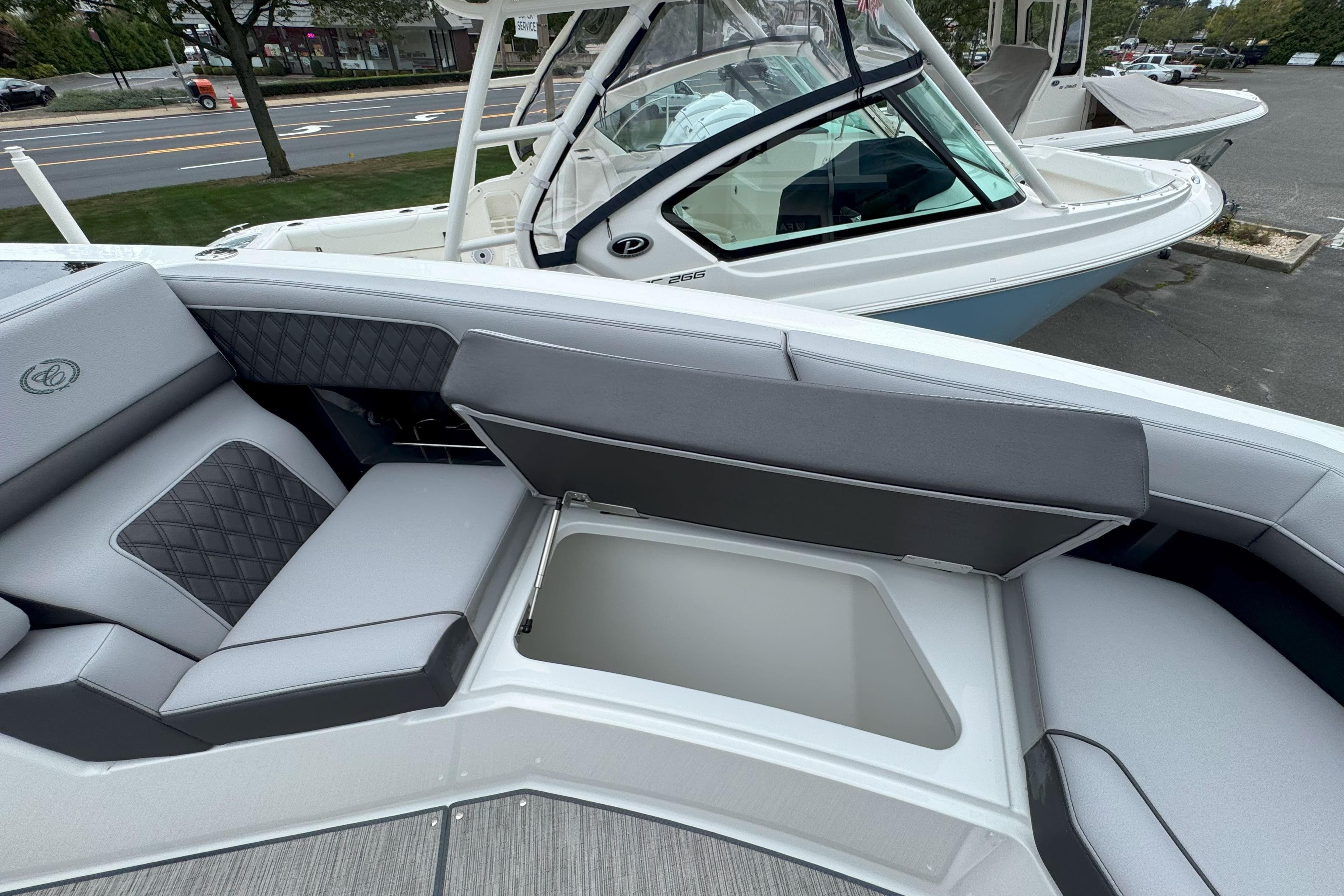 2025 Cobalt R33 OB boat with open storage compartment and luxurious seating.