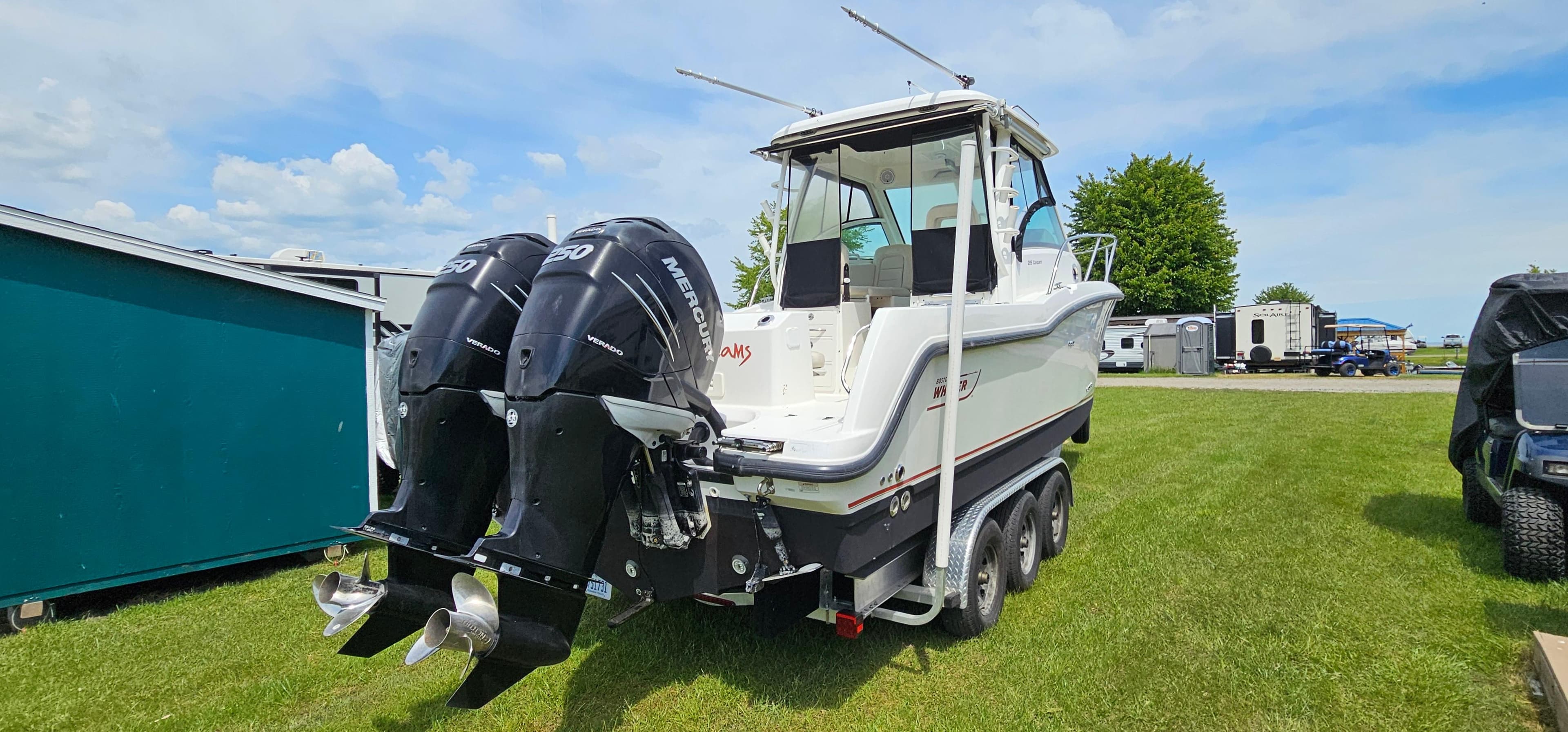 2016 Boston Whaler 285 Conquest boat with dual outboard motors on a trailer.