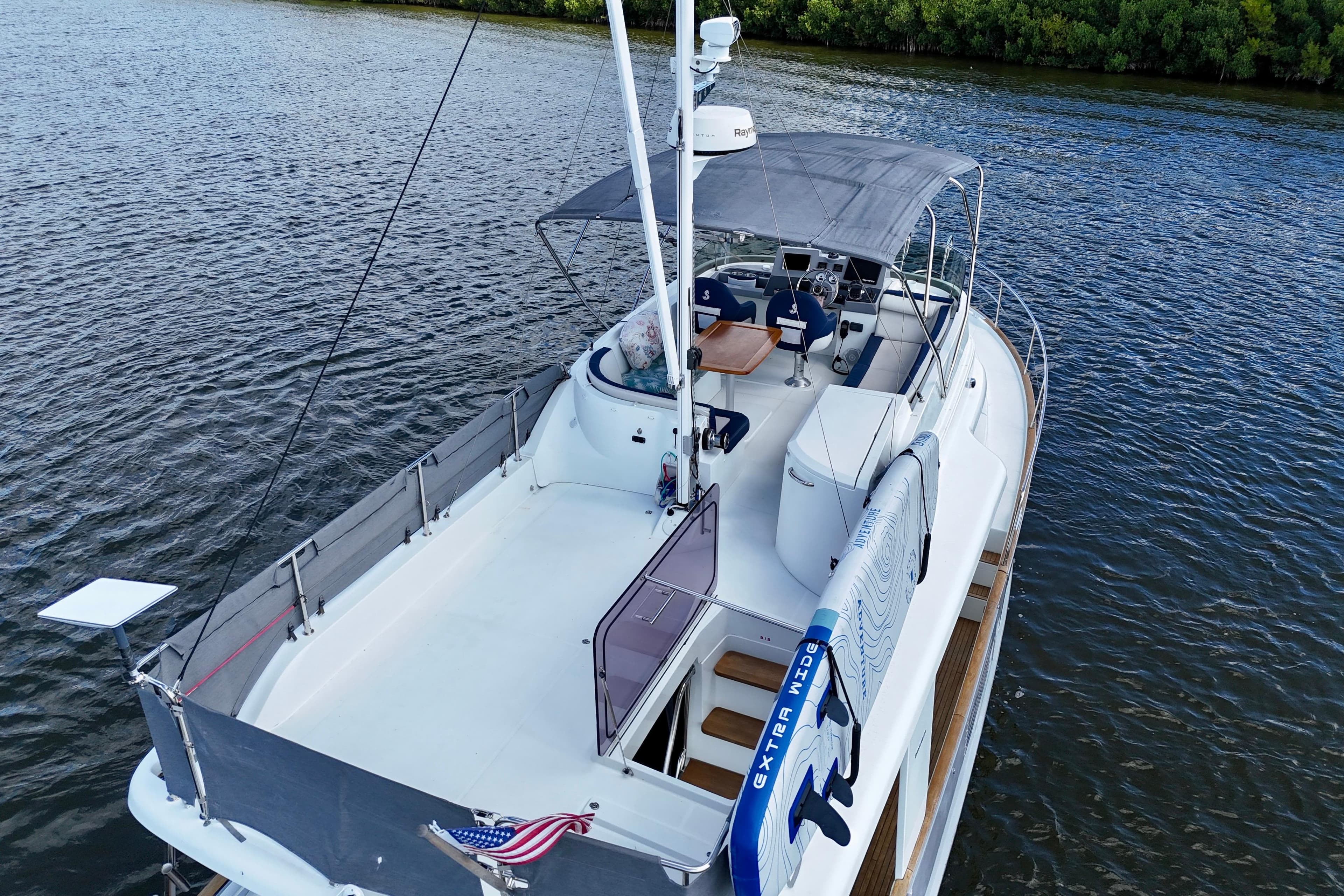 2020 Beneteau Swift Trawler 44 on water, featuring spacious deck and canopy.