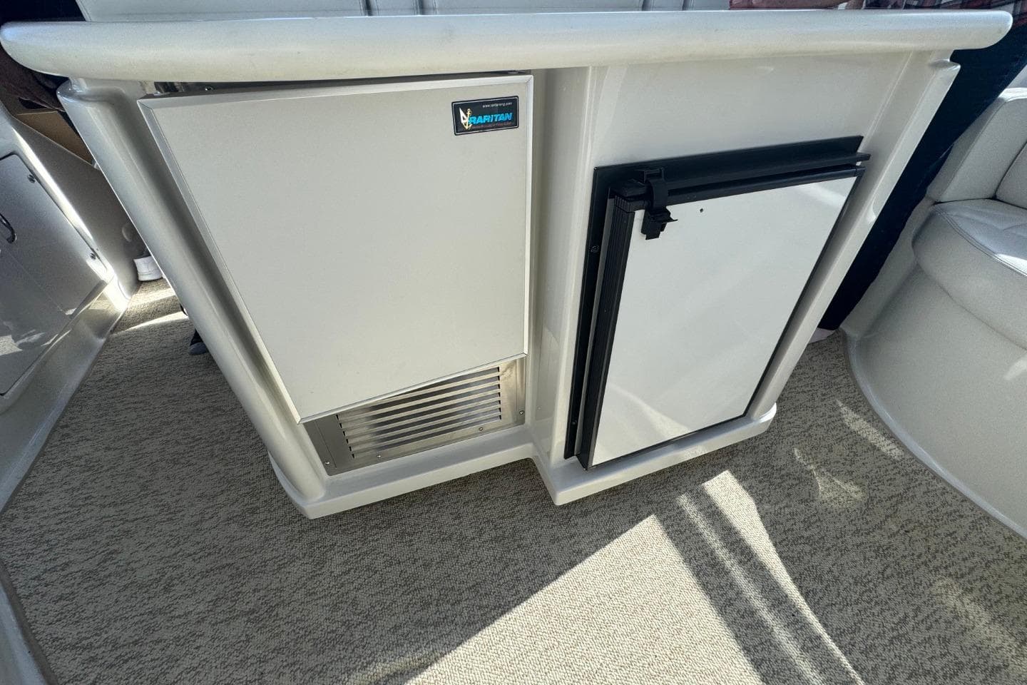 2004 Carver 564 Cockpit Motor Yacht interior with built-in refrigerator and storage.