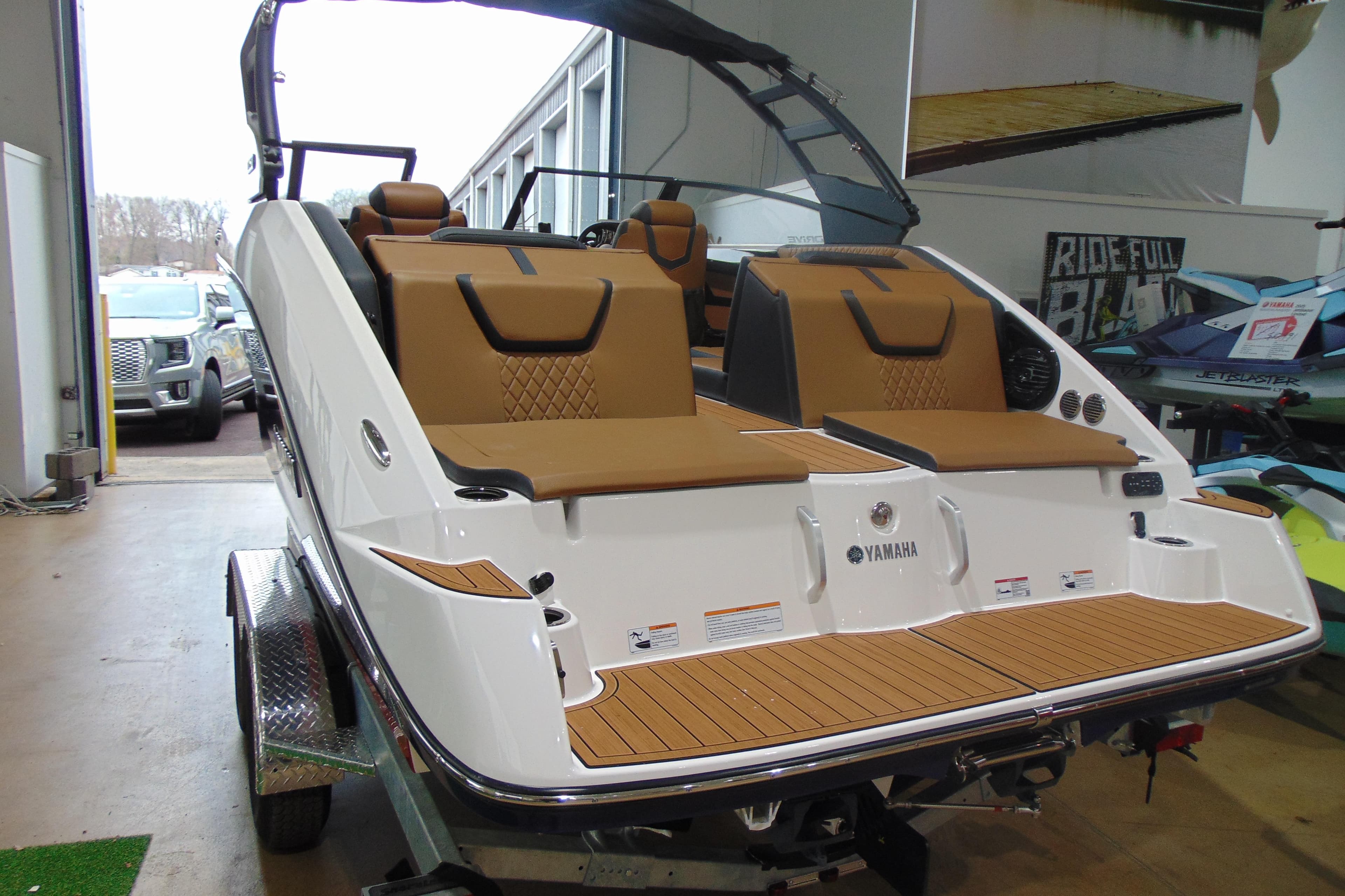 2026 Yamaha Boats 222SD with sleek design and tan seating in showroom.
